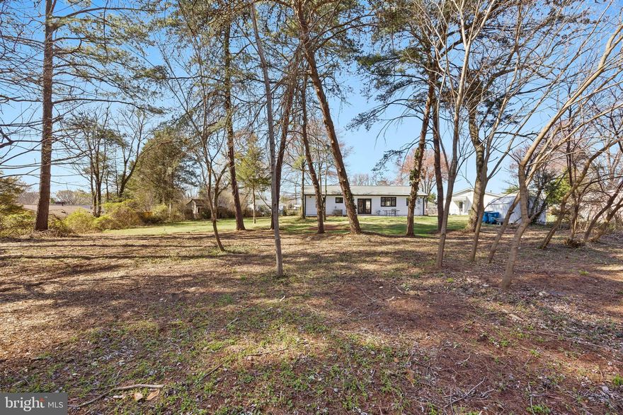 COUNTY APPROVAL JUST CAME THROUGH FOR BOUNDARY LINE ADJUSTMENT!  PROPERTY LOT SIZE IS NOW .7252 acre. The lot now includes the original .22 acres AND the adjacent property located directly behind the original parcel.
What a great place to sit and enjoy your very own park-like setting yard from the patio of this home.
The house has been thoroughly renovated, taken down to the framing and then rebuilt. Plumbing, Electrical, insulation, flooring throughout, cabinetry, counters, etc., all totally replaced. Now it’s ready for new owners to just move in and enjoy.

The home is beautiful with LVP flooring, neutral paint, recessed lighting and modern fixtures.  The kitchen boasts beautiful cabinetry, countertops, stainless steel appliances and an island that provides lots of workspace and eating space.  The laundry room features new washer and dryer, cabinets, a sink, and an expansive pantry closet. The hall bath and the primary suite bath have been renovated with modern tiles, vanities, sink and shower fixtures.

The renovated exterior includes all new black framed windows, gutters and downspouts along with the freshly painted house.  There is also an Electric Vehicle charging station.

 This home is conveniently located near shopping, dining, and commuter routes.  Less than 6 miles to 2 Metro stops. Easy access to Dulles International Airport, bike trails and public transportation.  30 miles to DC.
Close to libraries, parks, community recreation centers, and hiking trails.
This home offers the comfort and peace of mind of a fully renovated interior, making it an ideal choice for buyers seeking modern style and low maintenance living in a great location.
