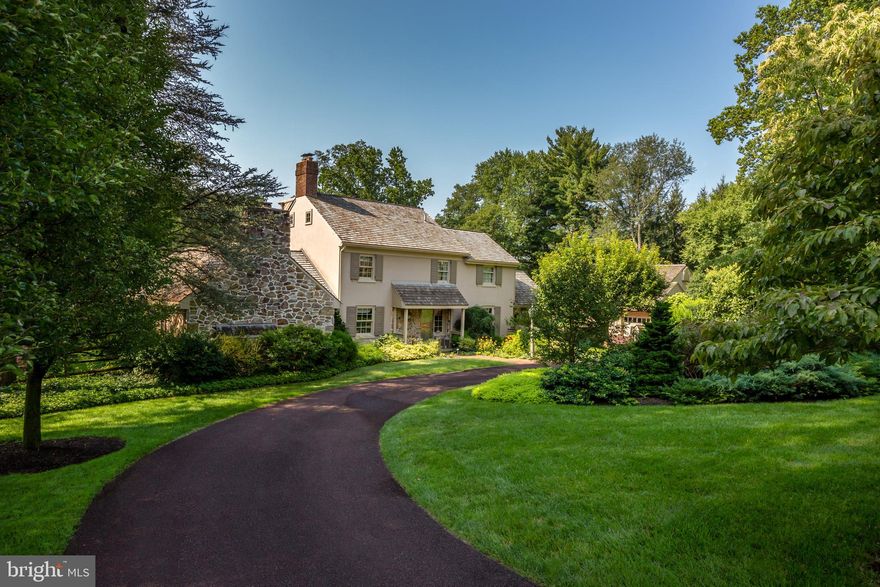 Fall in love with this elegant Warner-built home located a short distance from “the heart of Gladwyne.” Special features include timeless architectural details: fieldstone and masonry construction, cedar shake roofing, brick walkways, a circular driveway and custom, professional landscaping. Tastefully updated and expanded, the home’s architectural integrity has been thoughtfully maintained. Perfect for entertaining, the spacious interior boasts an expansive family room addition, multiple gas fireplaces, vaulted ceilings, elegant pegged hardwood floors, a main floor primary suite, and a whole house generator. All this on a private 1.39 acre fenced lot with a lovely in-ground pool and separate four-car garage. The first floor features a transverse entry hall, random width pegged hardwood flooring, custom millwork, a fireside living room with built-ins, and a separate, formal dining room.  A spacious kitchen includes butcher block counters, Mexican tile flooring and a vaulted, beamed ceiling. The fireside family room addition offers an expansive light-filled space for family gatherings with a vaulted ceiling, a large arched window, and access to a covered back porch, perfect for morning coffee while enjoying the “four-square” garden with its lush plantings. The private main floor primary suite includes a large bedroom with vaulted ceiling, two large closets, glass French doors to a balcony, a tile bath with large stall shower and a separate cozy fireside den with built-in book cases. The second floor includes two bedrooms, two baths and an office, providing access to a unique third floor bedroom with its own bath. The walk-out lower level has a full bath, a kitchenette, a finished multi-purpose space, a laundry room, utility room and storage. A separate four-car garage includes a potting shed and work area as well as an unfinished upper level with three cedar closets. A charming garden shed in the far corner of the property houses lawn equipment. A beautiful pool with slate surround and garden wall, professional landscaping and split rail fencing completes the exterior. The convenient location in the award-winning Lower Merion School District provides easy access to Philadelphia’s many historic and cultural attractions while the Main Line offers fine dining and exclusive shopping venues, including the new McCaffrey’s Food Market. Walk the network of trails, faithfully maintained by the Bridlewild Trails Association or just enjoy the private oasis this home provides.