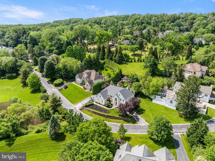 Welcome to 1261 Gulph Creek Drive, a beautiful six bedroom, four and one half bath home with all new James Hardie exterior and Roof in 2024 is located just minutes from the charming town of Wayne, PA. This home offers abundant natural light, timeless elegance with crown molding and wainscoting, expansive living spaces with a finished third floor and finished walk out lower level with separate entrance. The private backyard with heated pool and hot tub and the homes’ location across from the community open space provide lovely views. Enter the two-story Foyer with dramatic turned staircase with gleaming hardwood floors that continue into the Living Room, Dining Room, Family Room, Sunroom and up through the second-floor hallway. To the right is the Living Room and on the left is the Dining Room with wainscoting, a bay window and access to the Kitchen. Tucked away is a  home office with neutral marble floors and large windows overlooking the serene rear yard. A wet bar conveniently located at the Family Room entry has cabinetry and glass shelving. The grand Family Room with two-story ceiling and feature windows overlooking the lush rear yard has a gas fireplace with marble surround and is open to the eat-in-Kitchen. The gourmet eat-in Kitchen is a chef's dream, featuring an abundance of wooden cabinetry, granite countertops, and a center island with seating. Two large double door pantries and stainless-steel appliances make meal preparation a joy. A window above the sink provides a view of the private rear yard. The eat-in-kitchen opens to the Sunroom with cathedral ceiling and glass French door leading to the Patio. Conveniently located off the kitchen: Laundry Room, Powder Room, side door entry, and direct access to the three car Garage with built in storage shelves and cabinetry.  From the kitchen or foyer, take the beautiful turned staircase to the Second Floor. Down the hall with hardwood floors, is the Primary Suite with tray ceiling; a true retreat with expansive layout and multiple outfitted closets including a large walk-in.  An attached Bonus Room with two more closets and vaulted ceiling makes a perfect sitting room, fitness area or a home office. The luxurious Ensuite Bathroom features a large soaking tub, glass-enclosed stall shower, private water closet, linen closet, and a double sink vanity with granite countertops. Three additional Bedrooms on this level offer spacious closets and are serviced by two hall Bathrooms each with granite-topped storage vanities and a tub shower. The finished Third Floor offers a large Bonus Room with an oversized walk-in closet with custom shelving. Perfect media room, playroom, fitness area or additional bedroom.  Additional storage in the attic as well. Wainscotting continues from the foyer down the stairs to the fully Finished Lower Level with separate entrance, perfect for guests, in-laws, au-pair or home office. On this level, you’ll find a large living space with wood style floors, gas fireplace, 2nd Kitchen with island, dining area, one or two additional Bedrooms or Home Office,  Laundry and a convenient Full Hall Bath. The Backyard is a private oasis with an inground Pool and Hot Tub with waterfall feature surrounded by estate fencing. The Patio is covered by a retractable awning  and yard is filled with lush landscaping and screened-in gazebo. This home is serviced by the Upper Merion School District and is conveniently located close to many local restaurants, shops and parks. With easy access to major highways and public transportation, commuting to Philadelphia and surrounding areas is a breeze. 
MORE RECENT UPDATES: custom pool cover, whole house generator, washer/dryer in first floor laundry, kitchen refrigerator, two new heat/ac units (2018) and 75-gal hot water heater (2018).
***Seller will install new shutters prior to settlement if the Buyer would like them! HOA has approved the house with or without Shutters. (ordered and paid for already)