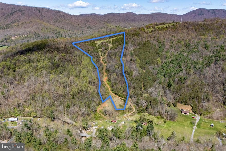 A view truly second to none on the East Coast! Located in the shadow of Bearfence Mountain and only 0.4 miles from the Shenandoah National Park, the photographs simply do not do this 18+ acre property justice. The panoramic views include a direct, unspoiled view of the Shenandoah National Park, Blue Ridge Mountains, and Skyline Drive. This property is surrounded by large tracts of land adding to privacy and seclusion.  Short-term rentals (STRs) are allowed by right after obtaining a business license from the Page County Commissioner of Revenue.  There is no HOA and no restrictive covenants. A four-bedroom septic letter and electric easement are already on record. A road provides access throughout the property including to the highest point.  The upper approximately eight acres of the property were formerly a cleared field where cattle once grazed and could be easily cleared again. Hunting on the property is outstanding with a mix of mature oak trees, clearings, and cedar thickets that attract and hold an abundance of wildlife. If you are looking to build a cabin in the shadow of Bearfence Mountain and the Shenandoah National Park with a truly one-of-a kind view, this is the property for you.