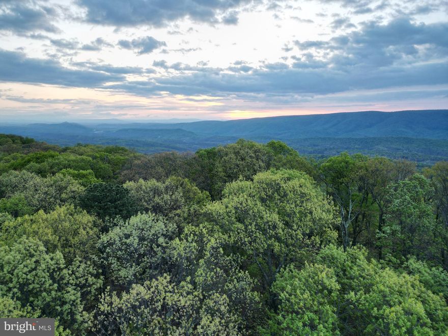 Tucked away along a well-maintained road, this scenic property offers a perfect blend of natural beauty and convenience. Large, mature oak trees are scattered throughout the landscape, creating a peaceful setting with character and shade. An elevated homesite provides stunning views across the valley and surrounding mountains, making it an ideal spot to build your dream home or getaway.

Enjoy breathtaking sunrises with minimal clearing required, while the natural terrain offers unique features like scattered rock formations—perfect for landscaping or crafting a custom driveway entrance. The land shows strong signs of deer activity, making it especially appealing for wildlife enthusiasts. Intermittent springs run throughout the property, adding to its charm and potential.

Conveniently located just 9 miles from Paw Paw, 14 miles from Berkeley Springs, and 42 miles from Winchester, this property offers both seclusion and accessibility. Whether you're looking to build, explore, or simply relax, this land has the setting to make it happen.