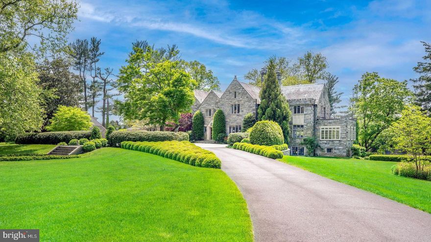 Beverstone, located on the National Scenic Byway of Kennett Pike and across from Winterthur Museum, Garden, & Library, was built by the du Pont family in 1927 and local lore has it named after the early 13th century Beverstone Castle in Gloucestershire, England. Constructed of solid stone and situated on 7.7 acres of stunning gardens and open space, this architectural gem is a hallmark manor estate in Greenville, Delaware. Gated entry leads to a picturesque drive up to the beautifully landscaped courtyard with circular driveway. The majestic home is elegant yet welcoming at the same time. Inside the distinction of the exterior continues and combines effortlessly with the comfort of home. An oversized front to back grand entrance hall with architectural details on the ceiling is highlighted by a graceful, curved staircase that accesses all three levels of the home. Expansive living room with fireplace and sunroom sitting area has exceptional views of the property through large windows. The library is a treat at all angles with rich, warm paneling, fireplace, and a phenomenal quatrefoil plaster ceiling. Palatial formal dining room with exquisite hand painted wallpaper and millwork wrapping the room. Well appointed, eat-in kitchen combines today’s modern conveniences with hints of old-world charm including built-in shelving. The kitchen opens to a den with brick flooring, exposed beams, and expansive windows allowing for natural light to fill the space. Upstairs you will find a sumptuous owner’s suite with two bathrooms, main bedroom with fireplace, a decadent walk-in closet, and a private upper terrace with vistas of the property. The 2nd floor is complete with 5 additional bedrooms, 4 full bathrooms, laundry room, and a foyer large enough to accommodate a playroom or sitting room. The eye for design found on the main and upper floors continues in the finished lower level with spacious family room with stone fireplace and true daylight windows enveloping the space, exercise studio and door leading to the exterior through the greenhouse. Breathtaking gardens and recreation opportunities surround the home including an in-ground pool, tennis court, pond, and an extensive terrace that takes advantage of the sweeping views of the estate. For the car enthusiast there is a four car attached garage as well as a two car detached garage. The detached garage offers additional living space on the 2nd floor. The detail with which this home was originally built has not been forsaken while modernizing and bringing to today’s standards. A true masterpiece from the moment you enter the gates.