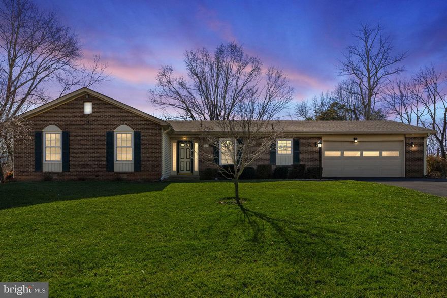 Lovely brick and vinyl siding rambler on the DC side of Warrenton.  This home has been updated with a new kitchen about 10 years ago.  Granite countertops, custom cherry  cabinetry, LG stainless steel appliances, ceramic back splash with great lighting, plenty of working space and glass front top cabinet doors.  Windows were replaced 2 years ago. Large Trex deck added in 2022.  Roof replaced about 5 years ago.  New water heater 2023.  Ceramic tile floors in the updated baths. Spacious walk in closet in Primary bedroom and ample closet spaces throughout this fine home. Private back yard with raised flower beds and beautiful landscaping. Serene setting for plenty of outdoor time.  There is underground electric fencing with collar for your furry family members.  Complete with an attached oversized garage and paved driveway.    Property is to be sold in "As Is Condition".