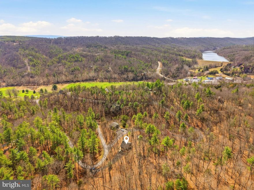 "Hogan's Nest - Charming, furnished, 3 bedroom, 2 bath, 1690 sqft mountain retreat. The home is only 0.2 mile from the driving range. Walk to the resort and restaurants in our area. This property has a paved driveway. Two levels of living space. The upper level features an open layout with the kitchen, dining area, and living room. This home offers a propane fireplace in the living area. There is also a bedroom and a full bathroom with double sinks on this level. A wraparound deck provides plenty of space to enjoy the outdoors while sipping coffee. The lower level includes two additional bedrooms, a family room with electric fireplace, a full bathroom with laundry area. The family room could also be used as an additional sleeping area. Walkout access to a spacious patio for an evening sunset. Being sold fully furnished. Would make a great full-time home, vacation property, or short-term rental. Bryce Resort offers the following: small airport, library, dog park, indoor pool, outdoor pool, lazy river, pickleball, tennis, playground, golf, mini golf, lake, mountain biking, skiing, snowboarding, ice-skating rink, and restaurants.  There is also a farmers' market on Wednesdays during the summer. Don't miss out on this great opportunity.