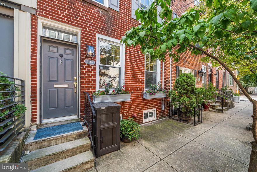 A sunlit sanctuary with skyline views, rare city conveniences, and timeless charm awaits on this idyllic tree-lined block. Step inside to discover 2140 Catharine St, a home that feels equal parts sophisticated and warmly inviting. With three spacious bedrooms with ample storage plus a versatile fourth room—currently styled as a cozy rustic den complete with a gas fireplace, Murphy bed, and private balcony—you’ll find flexibility to suit every lifestyle need. Light pours into the home’s heart: a sun-drenched dining room with charming built-in seating that doubles as hidden storage. The gorgeous, updated kitchen not only anchors the main level but features top of the line Frigidaire (induction cooktop and convection oven) and Bosch appliances. The kitchen opens beautifully into the private, sunny backyard—perfect for effortless indoor-outdoor living, grilling with friends, or tending to your own city garden. Practicality pairs beautifully with charm thanks to a two-car driveway with automatic rollgate—a rare city luxury. The home offers 2.5 baths, including a convenient powder room on the main living level, a hall bath on the second floor, and a fully renovated spa-like retreat with a dual vanity, expansive walk-in shower. Laundry is also found on the primary bedroom level. Upstairs, a stunning roof deck reveals sweeping panoramic views of the city skyline, your own private perch above it all. Thoughtful details abound—bedroom built-ins for added charm and function, a partially finished basement ideal as a children’s study and play space, newly installed hardwood stairs, and abundant natural light in every corner of the home. And outside your door? A walkable neighborhood with tree-lined streets, vibrant local shops like Ultimo Coffee, The Sidecar Bar, Dock Street Brewery, Loco Pez and all of Rittenhouse and Fitler Square just a short walk north. Don't forget about convenient access to the Schuylkill River Trail. The pulse of the City is at your fingertips here. This home offers more than just rooms; it offers spaces that inspire, soothe, and adapt—making every day feel like the perfect balance of city energy and personal retreat.