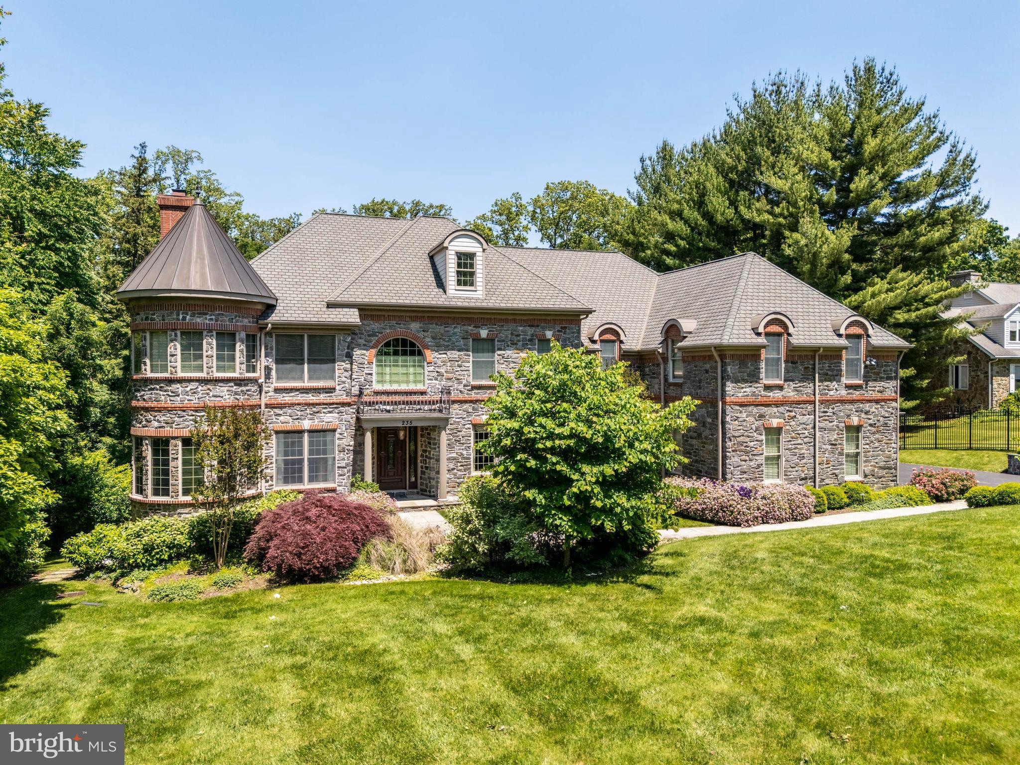 Discover the epitome of luxury living in this custom-built, gated manor home, exquisitely set on nearly an acre of lush landscaping, offering a serene and private setting. This sophisticated estate boasts impressive brick and stonework and an interior that reflects timeless elegance.
Step into the foyer, where gleaming hardwood floors, tasteful millwork and a striking turned staircase welcome you. The formal living room, adorned with a stately fireplace, and a grand dining room create the perfect ambiance for entertaining. The family room, featuring handsome coffered ceilings and a gas fireplace, is an inviting space with large windows that frame the picturesque greenery.
The gourmet kitchen, a chef’s dream, is equipped with high-end stainless-steel appliances, wine refrigerator, a large center island with breakfast bar seating, and crisp cabinetry. The seamless connection between the kitchen and family room extends to a rear stone deck overlooking the expansive grounds. The office/library, located conveniently off the foyer, offers a private retreat.
Ascend the main or rear stairs to the second story, featuring five bedrooms, three with ensuite bathrooms, a hallway bath (Jack and Jill), and a dedicated laundry room. French doors open to the luxurious primary suite and sitting room, which includes two large walk-in closets and a , sumptuous spa bathroom.
The walk-out lower level is an entertainer’s dream. The walk-out lower level is an entertainer’s dream, encompassing a large recreational area with kitchenette, wine refrigerator, and a full bath, along with a theater room for movie nights and a full gym. This home truly embodies elegance and comfort in every detail.
Floorplans of every floor can be found in the photos.
Future pool/pool house blueprints are available upon request.