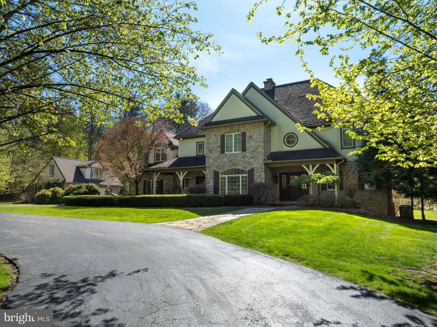 Located within the wooded enclave of Cedar Cliff, this one-of-a-kind French Provincial estate sits on 2.14 private, partially wooded acres—offering a rare sense of seclusion while remaining just minutes from State College. A striking stone-and-stucco façade introduces a custom-built home where timeless architecture meets refined, estate-style living.
Exceptional craftsmanship embodies over 5,299 finished square feet above grade luxury home. The dramatic two-story great room, anchored by a floor-to-ceiling stone two-sided fireplace and highlighted by the walls of windows, filling the space with natural light and warmth. Hardwood floors, crown molding, custom window treatments, and curated lighting elevate every space.
Designed to impress, the chef’s kitchen blends beauty and function with handmade inset cabinetry by Glick’s Custom Kitchens, an oversized marble waterfall island, two-tone quartz counters, farmhouse sink, gas range, wet bar, and a generous walk-in pantry. Vaulted ceilings with exposed beams and seamless patio access create an effortless flow for entertaining.
The main level also features a formal dining room with gas fireplace, a sitting room, a private guest bedroom with dual closets, full bath, and a well-appointed laundry room with folding station and sink. This home offers plantation shutters, tray ceilings, smart home features, and thoughtful design throughout.
The primary suite on the second floor serves as a retreat of its own, accessed by a separate staircase and offering a sitting area, office nook, three custom walk-in closets, and a spa-inspired bath with clawfoot soaking tub, dual vanities, and a multi-head steam shower. An additional three bedrooms and two baths, offer skylights, built-ins, and a loft overlooking the main living spaces. 
The finished lower level is an entertainers dream it contains an additional 2,393 square feet of finished space, complete with a custom wet bar: wine fridge, ice maker, dishwasher, media with projector and screen, and game areas, dining space, home gym, full bath, and patio access.
Outdoor living feels like a private luxury retreat. A covered flagstone patio with skylights, built-in kitchen, and integrated speakers opens to an expansive deck and a stunning two-story stone fireplace. Professionally designed grounds feature stone retaining walls, landscape lighting, and a full basketball court and plenty of room for a future pool.
Additional highlights include a detached two-car garage with a fully functional guest retreat with kitchen and bathroom. The property includes a dual access driveway perfect for inviting many guests. 
A true retreat—private, distinctive, and impossible to replicate. Schedule your private tour today!