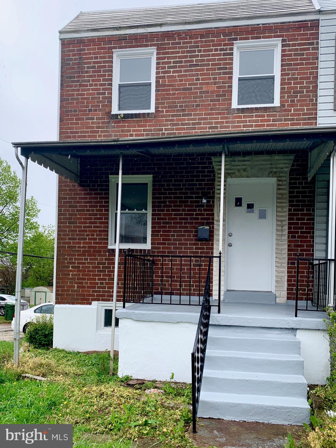 3 bedroom (possibly a 4th in finished basement) 1 and 1/2 bath beautifully rehabbed end of group row home! Brand new flooring, new cabinets and freshly painted. Lots of natural light and spacious front, side and back yard that is fully fenced in for you to enjoy. Also a new covered rear deck. Off street parking in private space on side. A must see!!