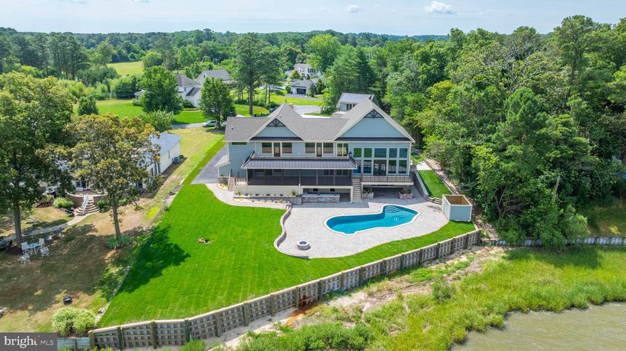 This beautifully and extensively remodeled home is ready for its new owner. This home sits on a 1-acre lot on the scenic Indian River Bay. Additional square footage was added to the first and second floor of this home during the expansive remodel. The panoramic water views are endless.  This home boast of 2 master bedrooms with walk-in showers in each as well as spacious closet on the 2nd floor. The main master bedroom on this floor is designed for a King and Queen with a dream His and Her closet, water closet and glass enclosed shower with free-standing tub. The second floor also has one guest bedroom and bath with tub beautifully done with a tiled surround. A large linen closet is situated in the hall for your guest. Each west facing bedroom on the second floor has deck access for you to enjoy the beauty and wild life the Bay has to offer. The main floor of this home has a beautifully crafted kitchen featuring Waypoint Cabinetry and over range hood, oversized appliances and Alleanza Quartz counter top, backsplash and very spacious island with matching water fall edge. This kitchen has a large bay front window over the sink, walk in pantry, and 8 ft slider that leads you to the spacious screened in porch. You will also find a large living room with floor to ceiling windows, a beautiful sitting area on the second floor that overlooks the living room.  The main floor also boasts of an additional master bedroom with access to the large screened porch and walk in closet. One additional large master suite on this floor could be used as an in-law suite.  This master has a private entrance along with a sizeable walk in closet and wet bar. There are 2 full size laundry rooms, one located on the main floor and a one in basement floor. Both are equipped with stackable front load Energy Star by GE washer and dryer, Waypoint Cabinetry with laundry basket pull outs. A rare find on the shore is the 1000 square foot completely finished walk out basement. Here you will find a sizeable wet bar area for entertaining with a full-size refrigerator, sink, build in trash can, microwave and dishwasher. The room has an island with overhang on 3 sides for your guest to enjoy the view of the pool as well as the bay. This room also has a gas fireplace for the cold chilly nights, flex room which could be used as a gym, media room or even sleeping quarters. A full-size bathroom completes this space nicely for your guest. Once out on the expansive paver patio, the large inground concrete pool invites you to enjoy the summer air with friends and family. This spacious patio has plenty of room for the sun goddess of your family to enjoy as well as covered entertainment space. The outside bar area has a large sink, beverage cooler and ice maker, storage, full size bathroom and a granite counter top covered bar area will entice swimmers to enjoy a cold beverage while watching the boat traffic on the bay.  Also included on this property is an additional 2 car garage with flex room above. A full bathroom completes this flex room.  The Community has a private boat doc. The boat slip assigned to this property by the HOA is slip #1. This beauty will not last long. Make this your dream water front oasis.