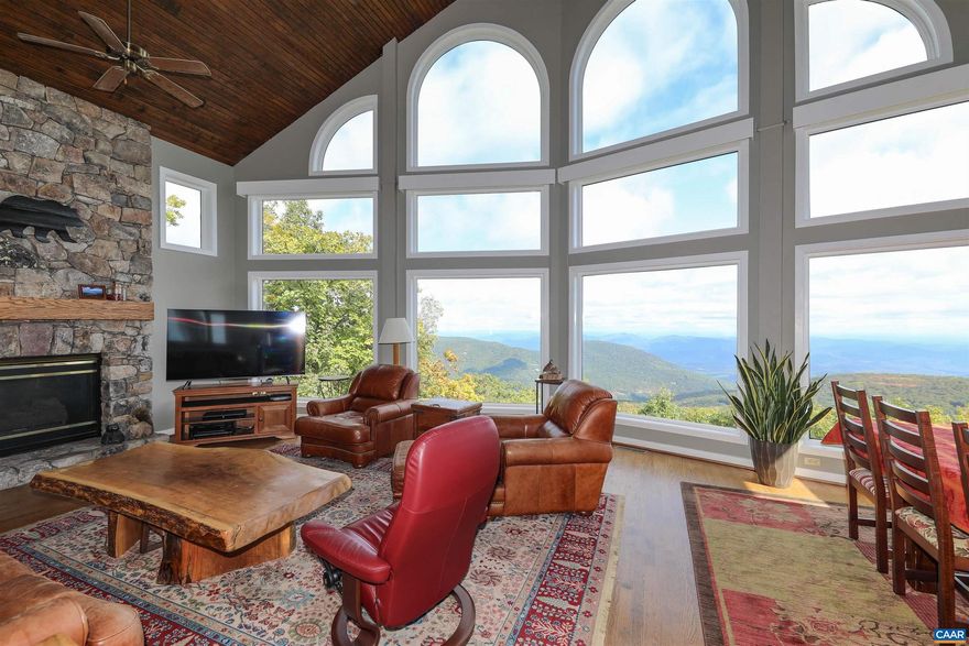 Views are everywhere at this classic mountain retreat nestled in the heart of the Blue Ridge Mountains. This home is designed to capture the beauty of the great outdoors while providing modern day comfort. Upon entering, you'll be greeted by vaulted ceilings and a magnificent natural stone gas fireplace, providing both rustic warmth and cozy ambiance. Large view windows flood the area with natural light, allowing you to take in the stunning year rounds views while enjoying the warmth of passive solar heating. Only two steps to enter the house, boasting 6 bedrooms, 3.5 baths with a spacious master suite on the main level, designed for your utmost comfort and convenience. Not to mention an attached two-car garage with extra storage. Whether you're seeking a weekend getaway or a year-round residence, this classic mountain house offers it all.,Cherry Cabinets,Granite Counter