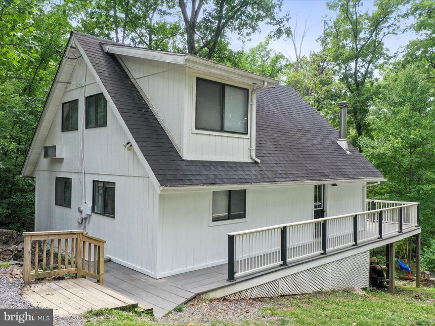 Discover your serene retreat in Gerrardstown with this charming, affordable home. Nestled in a secluded setting, it boasts calming views from a spacious wraparound deck. Enjoy peace of mind with a new roof installed just three years ago. The classic white siding with black accents adds a touch of modern elegance to the exterior. Inside, you'll find a fresh and inviting space with new flooring, updated paint colors, and sleek granite countertops. The convenient laundry room adds to the home's appeal. Whether you're a first-time buyer, looking to downsize, or seeking a weekend getaway, this home is a perfect fit. Plus, stay connected with reliable Xfinity internet service. Come see how this lovely home can meet all your needs!