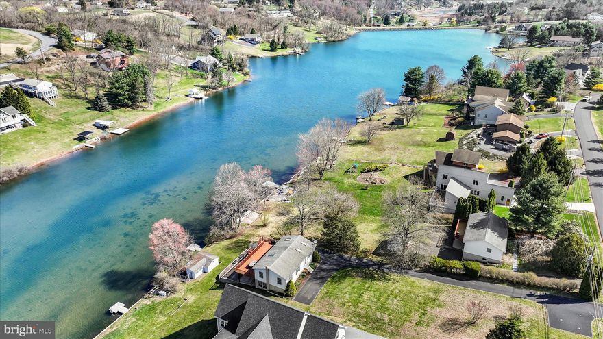 **New Listing — Lakefront Living on Fawn Lake**
Welcome to your dream retreat — a move-in ready, meticulously cared-for 3-bedroom, 2-bathroom 2,050 square foot home nestled on 0.4 acres of pristine lakefront property. Bright, clean, and brimming with character, this gem offers gorgeous sunset views and an easy stroll to the crystal clear waterfront. Step inside to a vaulted living room that creates an airy, open atmosphere, flowing effortlessly into the dining area and well-appointed kitchen — perfect for entertaining or quiet evenings at home.  3 bedrooms and an updated bathroom grace the main floor. The spacious basement is brimming with potential, ready for your personal vision. A family room and an additional bathroom plus laundry area and workshop space accommodate family and guests alike. Notable, functional features include Andersen sliding doors, two mini-split systems for efficient year-round heating and cooling, paved driveway, and on-site septic. Outside, the appeal continues. A large deck with superior views, stamped concrete patio, extensive hardscape with retaining walls, storage under the deck, a shed, and a floating dock enhance this property's outdoor living space. Fawn Lake is a private, 27-acre gem known as the "Little Lake" — specializing in non-motorized and electric-only boating, swimming, and fishing. With 45-foot depths, a dedicated boat launch, pavilion, and serene non-wake atmosphere, tranquility is guaranteed. The dam/spillway was repaired in 2009, and this lake is functioning at full pool. Located within the gated Lake Wynonah community, residents enjoy 1,476 acres of rolling hills, 27 miles of paved roads, a community pool, lodge, and crystal-clear waters. This is lakefront living at its finest.