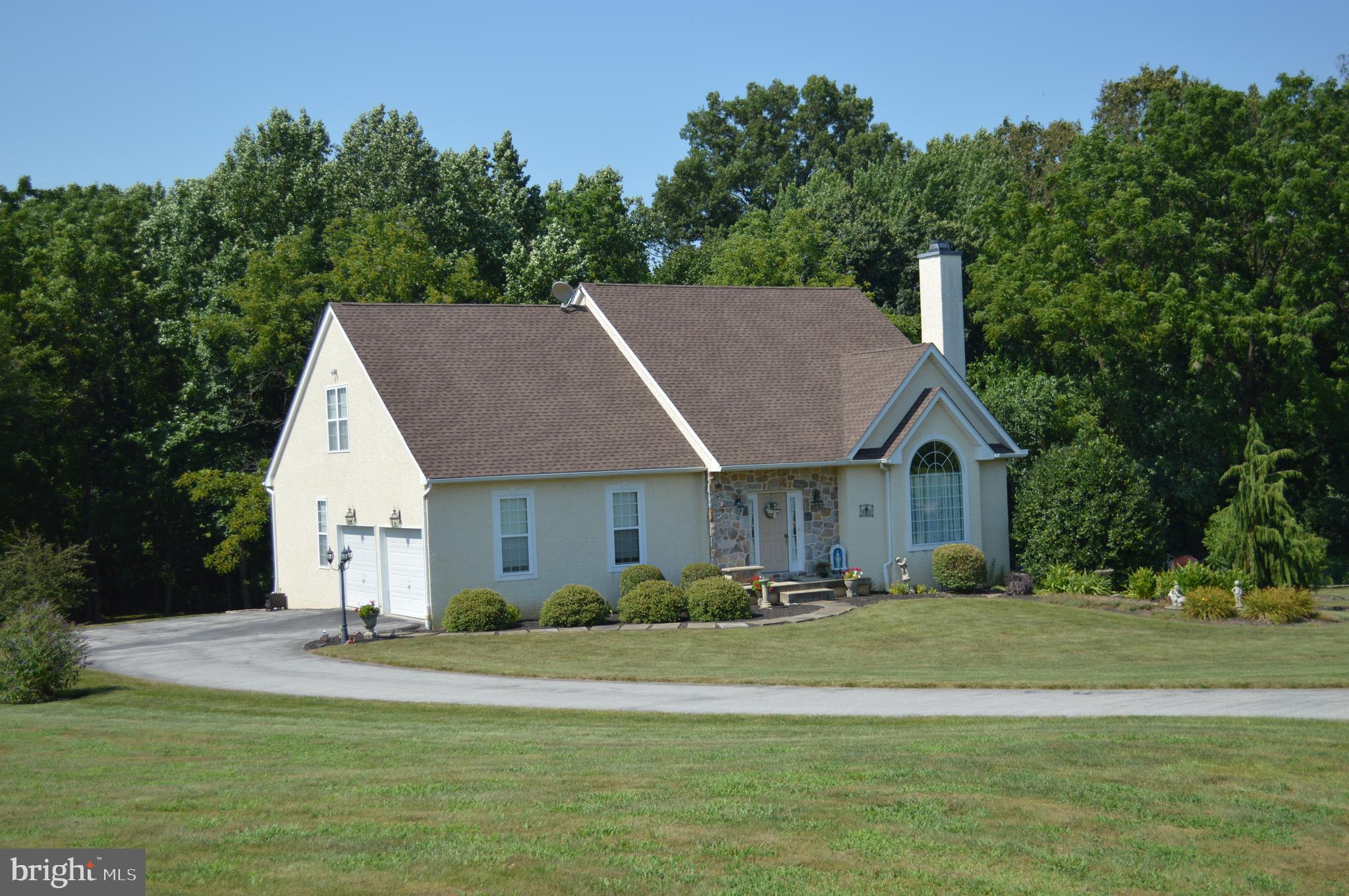 Welcome to this well maintained home on a picturesque 2.35 acre lot. The first floor features a wonderful master suite w/full bath, family room with fireplace, and 18 ft vaulted ceilings. The kitchen is spacious with a huge pantry, separate dining area and sliders to the rear deck. First floor laundry/mudroom leading to the attached 2 garage and half bath complete this floor. The second floor boast a second master bedroom with walk in closet, 2 additional over sized bedrooms and full hall bath. The walkout basement is complete with heat, a/c and lots of natural light.This area awaits your finishing touches.
