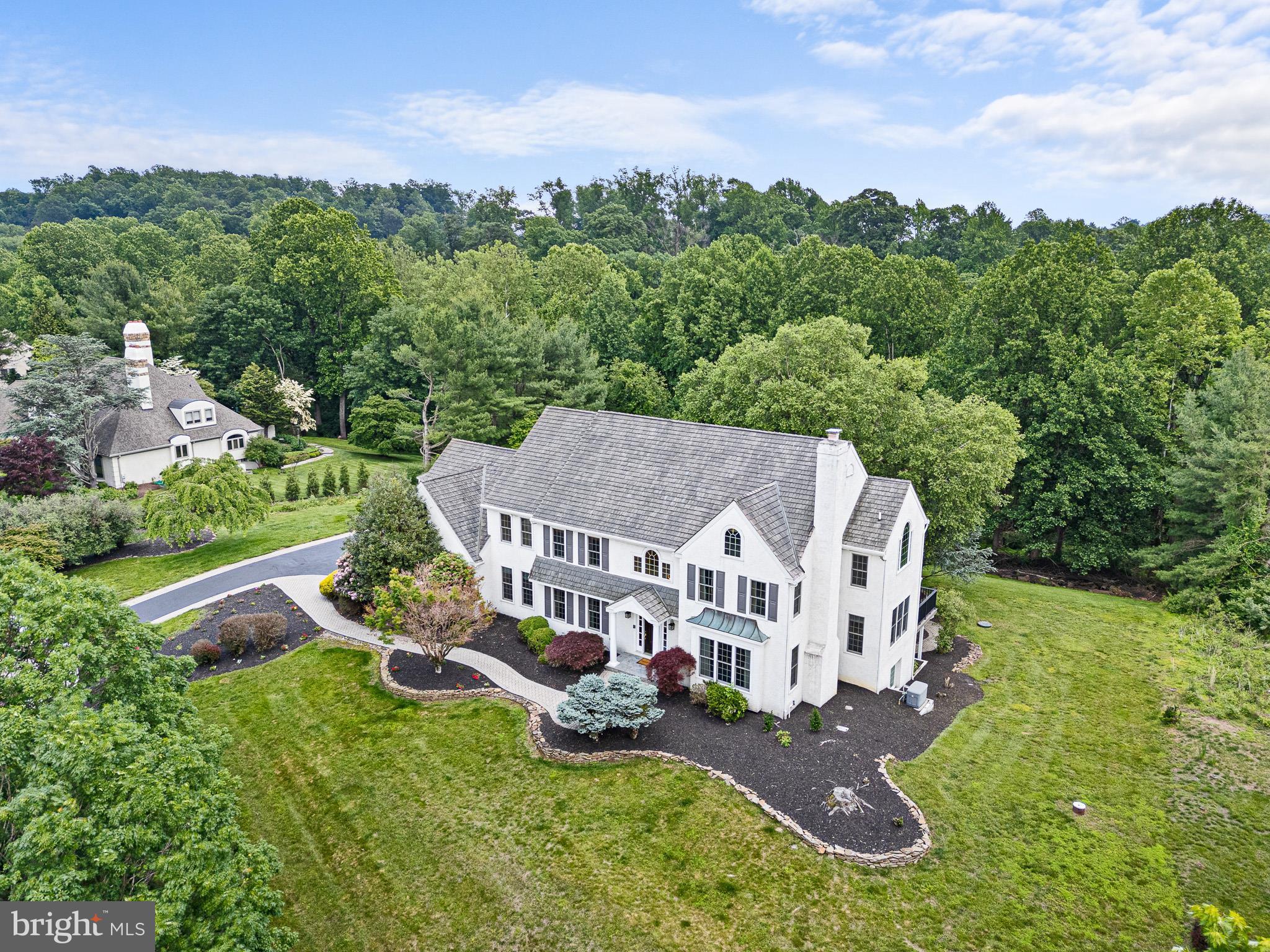 Private Wooded 2+ acre lot situated in the Heart of Greenville! Style and grace describes this Stunning 5 bedrooms 4.2 Baths Estate designed with exquisite details. The foyer presents an elegant turned staircase, rich oak hardwood floors throughout. backing to Fieldstone Golf Course and nestled on over 2 acres of gardens, tranquil open space, with panoramic views, extensive hardscaping, and a peaceful stream flowing through the rear of the property. Approximately 7000 square feet of living space, this home offers an ideal layout for hosting large gatherings. A paver walkway leads to the front door where a covered and newly marble tiled (2025) porch. Formal living room, with a gas fireplace for seasonal comfort and great for entertaining! The Family room showcases a floor to ceiling stone fireplace and towering palladian windows, a wet bar with glass fronted cabinets and a beverage fridge, with access to the composite deck. For added convenience a 2nd powder room is located between the family room and living room. The kitchen is a chef's dream with granite countertops, Sub-Zero refrigerator, Wolf double ovens, Wolf four-burner gas cooktop, Dacor microwave cabinet, stone backsplash, a large island with guest seating, dual sinks, and a large pantry. Connecting through a butlers pantry is the formal dining room with tray ceiling, wainscoting, and space for 12+ guests. Off the family room is a bright sunroom with sliding glass doors to a private composite deck. Near the kitchen a short hall leads to the Laundry room with generous cabinetry, a second staircase to the upper level, and another powder room as well as garage access. Upstairs, the primary suite is a luxurious retreat, featuring two walk-in closets, tray ceiling and tri-mirrored dressing corridor. The spa-like bath includes a jetted Kohler tub, oversized tiled shower with bench, dual vanities, private water closet. To complete this level are 4 additional bedrooms and an updated full hall bath. The princess suite with its own updated full bath and walk-in closet. The fifth bedroom could also serve as an office or bonus space.Adventure to the lower level designed for entertaining and recreation. Enjoy a full media room with Spanish tile floors, and tiered seating. Adjacent is a library with built-in shelving, a mirrored billiard room with granite wet bar, four-tap Advanco kegerator, and beverage fridge. An exercise room gym with rubber flooring, an updated full bathroom, utility closets with geothermal heat pump, Rinnai on-demand propane water heater, whole house water filtration, and dehumidifier complete this level. A garden room offers a place for your favorite plants and seedlings and well as walkout access to the rear gardens. The oversized turned 3-car garage has new doors (2025), professionally outfitted with custom-grade steel cabinetry, a lift, and an epoxy-coated floor. Outdoors, the property boasts a stacked stone pond with waterfall, gazebo, extensive hardscaping, a massive composite deck and great privacy. Other amenities include a propane powered whole-house generator, 400-amp service, invisible fencing, septic, and recent stucco repairs. This exquisite Greenville home combines privacy, elegance, and thoughtful design. Just minutes from Coverdale Farm, Winterthur, multiple parks and points of culture and interest. Schedule your private showing today.