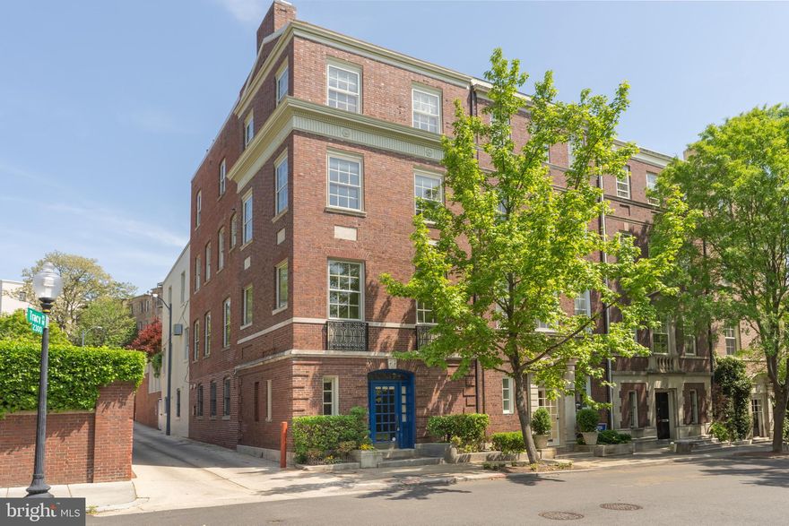 Presenting this distinguished end-of-row townhome in Kalorama, offering 5 bedrooms, 5.5 bathrooms, and over 4,700 square feet across four gracious levels. Originally constructed in 1916 and masterfully reimagined by architect Outerbridge Horsey in 2012, the residence blends timeless architectural character with elegant modern updates. Classic crown moldings, intricate trimwork, soaring ceilings, and rich hardwood floors reflect the home’s original grandeur, while 24 additional side windows flood the interiors with natural light and frame verdant views of neighboring gardens and historic homes.

A marble foyer sets an elegant tone upon entry. Ascend the central staircase to the main level, where a gracious gallery opens to formal entertaining rooms: a living room with oversized windows and an ornate fireplace, and a formal dining room with another handsome fireplace, flowing effortlessly into the gourmet kitchen/ family room. Thoughtfully designed for both everyday living and entertaining, the kitchen features a large center island, custom cabinetry, chef-grade appliances, and French doors opening to a flagstone patio and a private garden terrace just above the two-car garage - an idyllic outdoor extension of the living space.
The second level hosts the king-sized primary suite, complete with a custom-built dressing room, a marble-clad ensuite bath with dual vanities, soaking tub, and glass-enclosed shower, and multiple skylights that bring in abundant natural light. A second bedroom or library/office with an ensuite bath completes this floor. The top level offers two additional bedrooms and two full baths (one ensuite), with generous storage throughout.
The entry level provides remarkable flexibility, featuring a large family room, gym or office, guest bedroom, full bath, laundry room, and a powder room for visitors. A spacious two-car garage completes this exceptional offering.

Set in the heart of Kalorama—just moments from Embassy Row, the city’s finest cultural institutions, and a charming selection of neighborhood cafés—this is a residence of enduring elegance and distinction. A home without compromise.