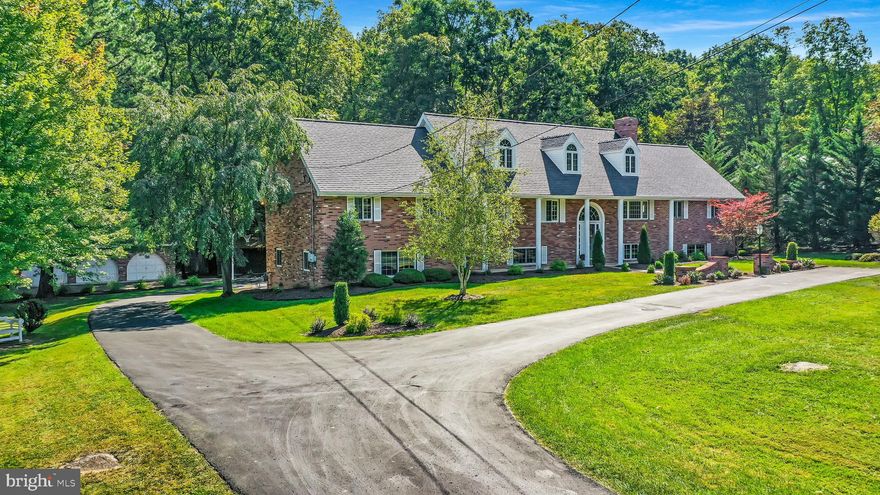 Rare opportunity for a large brick colonial home in the desirable Gramlich Rd neighborhood in the heart of LaVale.  This vast estate sits on 1.55 acres professionally landscaped by Nature's Art  and offers 5 garages for the car enthusiast. (Detached garage has trough drain and water hook up) Inside, enjoy multiple large living spaces including a great room with cathedral ceiling and custom raised wood panel  walls,  a cherry wood paneled family room with fireplace, bar, and built-in bookcases, or the custom designed sports room outfitted with wooden ACM basketball gymnasium bleachers.  This one owner home  includes 4 bedrooms including a large master suite with vaulted ceiling, cedar lined window seat, and antique claw foot tub.  If that wasn't enough space, there is a bonus room upstairs with extensive storage, dormers, and rear palladium window. Time outdoors can be enjoyed in multiple places  as well, including the covered composite porch off the great room,  the extensive brick patio off the family room,  or the private wooded picnic area across the bridge over a trickling stream.  Call today for a private showing!