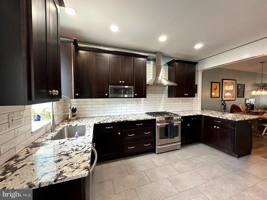 Pride of ownership abounds in this charming, turn key, home.  Enjoy a spectacular kitchen with granite, stainless, recessed lighting,  island seating, and storage for days.   Upstairs find two large bedrooms an updated bath, an office easily used as a third bedroom, new flooring, and great closet space!
The lower level features a family room or additional bedroom, half bath, and tons of storage.  
The owners have lovingly included unique built in features throughout the house.  Last but certainly not least enjoy easy off street Parking!