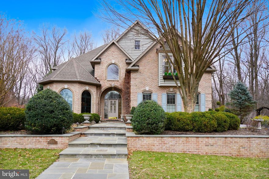 Beautifully designed 6 BR-5-1/2 bath all brick residence w/ a free flowing open flr plan that has everything today's buyers are looking for + a private 1.37 acre level lot---A 2 story front entry hall w/ a 19' ceiling leads to an open Lrm & Drm w/ decorative molding, columns, oak flrs & a guest Brm/Office w/ Ensuite bath---Additionally on the 1st Lvl is a mudroom, powder rm, breakfast area, wet bar & family rm w/ FP & built-ins---A  23x20 "Cook's" kitchen loaded w/ cabinets, granite ctops, 6 windows, a 10' granite island, Wolf SS 6 burner cooktop, Wolf SS double wall ovens, SubZero SS refrigerator, 2 KitchenAid SS dishwashers, a hanging pot rack & a built-in desk---A luxurious MBRM suite w/ FP, a large walk-in closet & an amazing mas bath w/vaulted ceiling, a Jacuzzi tub, glass shower & 2 vanities w/ marble ctops---Custom built-ins, molding, plantation shutters & lighting throughout---2 FPS---2nd flr laundry rm---38'  L-shaped clubroom w/ full bath---Parking includes a 2 car + a 1 car garage + a 2 car parking pad---Bluestone walkways---Relax on the Bluestone patio w/ a Lynn built-in gas grill backing to the woods.