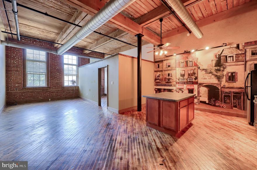 Enjoy easy 1 floor living in this bright and modern condo featuring 18’ ceilings, historic charm, exposed brick walls with 10’ windows and original hardwood flooring with lots of natural sun light. Take advantage of the 10,000 sq ft courtyard offering 2 water features with plantings and numerous social areas with bbq grills. Secure underground parking garage with 2 reserved spaces and secure main entrance with intercom. Great location, close to parks, restaurants, UPMC Memorial, OSS Hospitals and Route 30. Bright and open floor plan is great for entertaining. A spacious kitchen features a center island, stainless steel appliances, and dining area open to the living room. A guest bath and bedroom are conveniently located off of the open area. A primary bedroom with a private bath and laundry area complete the main level. This 19th century Silk Mill building was renovated in 2007 and offer private 2nd & 3rd floor condos and 1st floor offices. Schedule your private tour today to explore all of the wonderful amenities and features this wonderful condo has to offer.