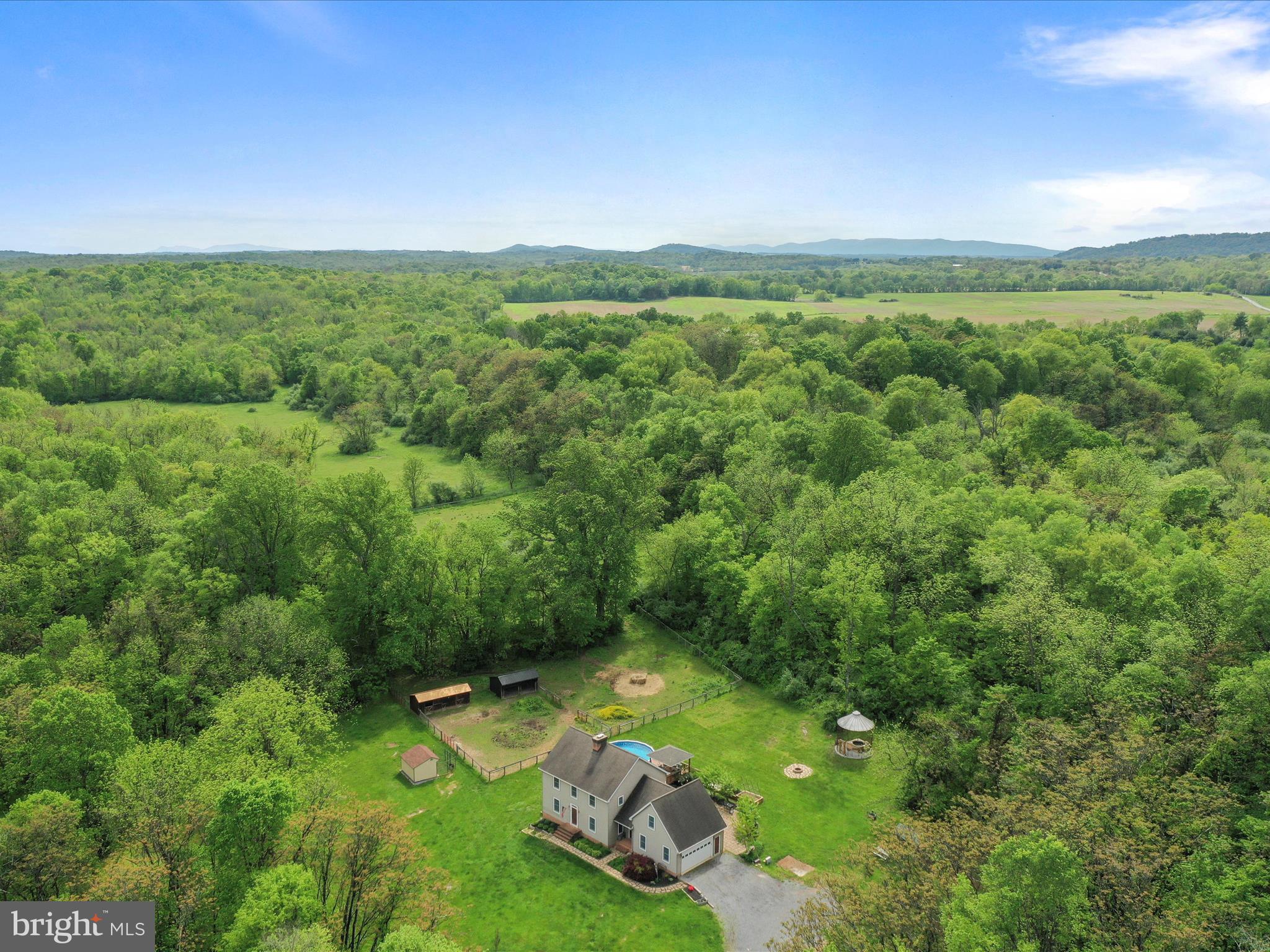 Charming Saltbox Colonial Farmette on 22.54 Acres. A private retreat with endless possibilities!
Welcome to your dream countryside escape! Nestled on over 22 picturesque acres, this classic Saltbox Colonial-style home offers the perfect blend of traditional charm, modern comforts, and farmette living. Boasting 4 spacious bedrooms and 2.5 baths, this inviting residence features stunning Brazilian cherry hardwood floors on the main level, where you'll find a cozy living room with a brick wood-burning fireplace, a separate formal dining room, and a beautifully appointed country kitchen complete with granite countertops, apron-front sink, stainless steel appliances, island, display cabinetry, and a cheerful breakfast nook.
A flexible main-level room offers endless possibilities for a den, playroom, or guest space, while a large laundry/mudroom and half bath add everyday convenience. Upstairs, the generous primary suite offers dual closets—including a walk-in—and a roomy bath with a 6-foot jetted tub / shower, and double-sink granite vanity. Three additional large bedrooms, a full hall bath, and ample storage complete the upper level. The unfinished basement offers future expansion potential and features a high-efficiency Jøtul woodstove for added warmth and charm.
Outdoor living shines here with a screened rear porch, gazebo, above-ground pool with deck, patio, and fire pit. The grounds include a unique corn crib converted into a cozy sitting area with a koi pond, three versatile sheds, raised garden beds, and private pond. Animal lovers will appreciate the fenced two-stall barn, run-in shed, and invisible fencing with collar.
This custom built home is surrouded by natural beauty, partially wooded areas, abundant wildlife, and backs to 100 acres of protected farmland. All just minutes from the Virginia state line—perfect for commuters seeking serene living with easy access to amenities. This one-of-a-kind property offers the perfect backdrop for your country lifestyle!
