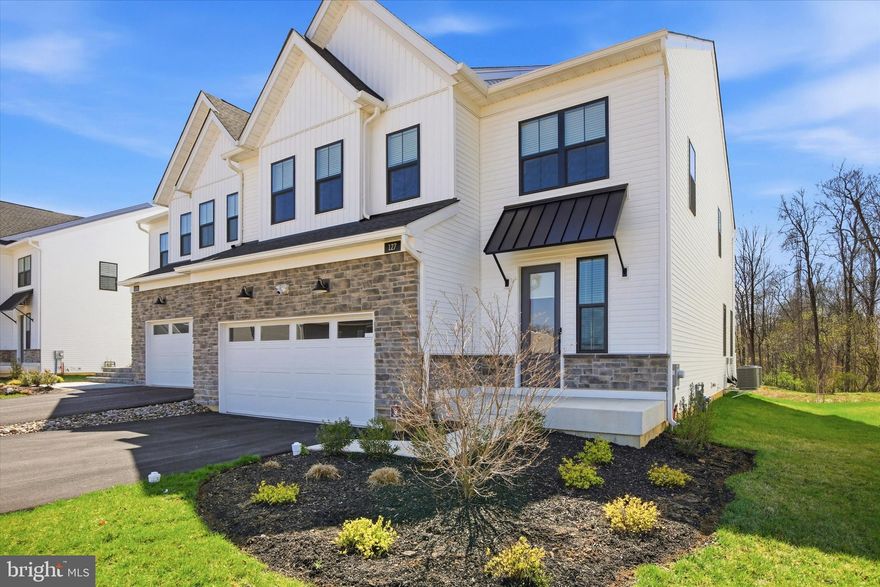 Welcome to 127 Alroy Road -  a stunning contemporary new construction home situated on a premium lot in the highly sought-after Anfield at Malvern community. This exquisite 4 bedroom, 3.5 bathroom semi-detached carriage home offers many upgrades throughout while it's thoughtfully designed layout is tailored for modern living. The open-concept main level seamlessly connects the great room and casual dining area, creating an effortless flow for everyday living and entertaining. The beautifully appointed gourmet kitchen features a long center island, expansive walk-in pantry, Kitchen Aid stainless steel appliances including newly added fridge and direct access to a spacious rear deck, perfect for indoor-outdoor gatherings. A powder room and attached two-car garage with 2 electric vehicle chargers complete the first floor. Upstairs, the luxurious primary suite offers a large walk-in closet, double sink vanity, private water closet, and separate shower. A secondary bedroom includes its own en-suite bath and walk-in closet, while the third and fourth bedrooms share a generously sized hall bathroom. This level is completed with a spacious laundry room with cabinets, utility sink, and newly added washer and dryer. The finished basement provides additional versatile living space while still offering ample storage. The community of Anfield at Malvern offers amazing amenities including a club house, outdoor pool, pickle ball courts, a playground, and a walking/jogging path. All of this while being in Top Rated Great Valley School District, close to all major roadways for an easy commute, and minutes to a variety of shopping options in Malvern and King of Prussia. Why wait for new when this beautiful property is ready now- Call today to make your appointment!