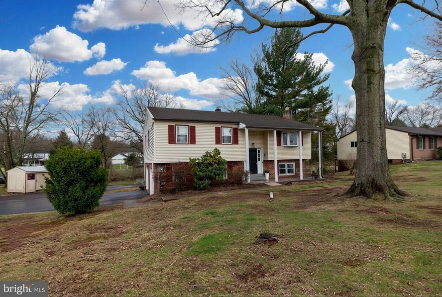 Nestled in the serene community of Grandview Acres, this charming bi-level home offers a perfect blend of comfort and functionality. Built in 1975, this well-maintained residence features a classic brick front and vinyl siding, exuding timeless appeal. With three spacious bedrooms and two and a half bathrooms, there's ample room for relaxation and privacy. Step inside to discover a modern and inviting open concept floor plan that is perfect when gathering with loved ones. The main level will be a treat to spend time in....with the living room, dining space and kitchen as one giant space....the entire home offers upgraded luxury flooring and a neutral paint palette....the kitchen features granite countertops, and a classic backsplash to dress it all up....with a full compliment of stainless steel kitchen appliances...The daylight basement provides additional living space which is made warm and cozy by the pellet stove insert fireplace, along with a convenient powder room.. This area is ideal for a home office, playroom, or entertainment area. The convenience of a basement laundry adds to the home's practicality. A huge bonus is the attached oversized two car garage and enlarged driveway for off street parking....Enjoy the outdoors on the enclosed porch, where you can sip your morning coffee or unwind after a long day, all while overlooking your expansive 0.51 corner acre lot.  This home offers central air for the summer weather to come!  This property is not just a house; it's a place to create lasting memories. With its inviting atmosphere and thoughtful layout, it's ready to welcome you home. Don't miss the opportunity to make this delightful residence your own!