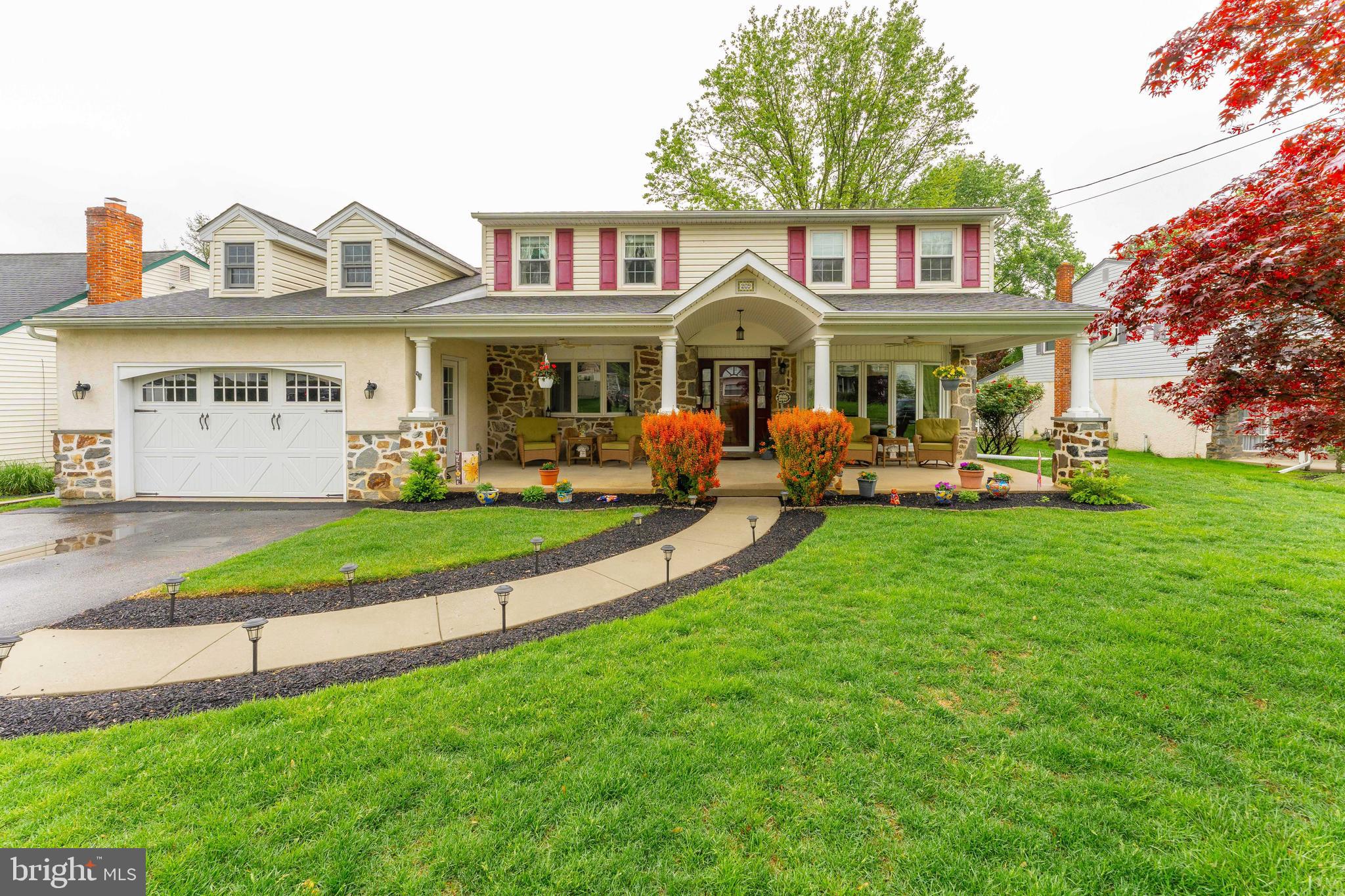 Welcome to 209 Beechtree Drive — a beautifully maintained 5-bedroom, 3.5-bath Colonial nestled in the desirable Parkwynne Estates neighborhood of Broomall. From the moment you arrive, you're greeted by charming curb appeal featuring a spacious front porch with ceiling fans—perfect for relaxing outdoors—and a two-car garage with convenient attic access. Step inside to a warm and inviting foyer with gleaming hardwood floors and tasteful lighting. To the right, a cozy formal living room boasts hardwood floors, a bow window, and elegant chair rail detailing. To the left, the formal dining room mirrors these finishes, creating a refined space for gatherings and celebrations. Down the hallway, discover a versatile first-floor bedroom complete with carpeted floors, a ceiling fan, walk-in closet, and easy access to a full bath—an ideal setup for a home office or guest suite. The full bath features tiled floors and a step-in shower. The heart of the home is the updated kitchen, showcasing hardwood floors, granite countertops, rich wood cabinetry with under-cabinet lighting, and stainless steel appliances. An adjoining breakfast nook provides a sunny spot to enjoy your morning coffee. Just off the kitchen, a well-appointed laundry room includes tile flooring, built-in cabinets, a utility sink, and direct access to the backyard. The expansive family room is a true highlight—offering hardwood floors, a semi-vaulted ceiling, a ceiling fan, a cozy gas fireplace, and sliding glass doors that open to a spacious back deck—creating the perfect indoor-outdoor entertaining flow. A convenient powder room completes the main level. Upstairs, retreat to the serene primary suite with plush carpet, a ceiling fan, and a dedicated dressing area featuring dual walk-in closets. The en-suite bathroom is appointed with tile flooring, a granite-topped vanity, and a step-in shower. Three additional generously sized bedrooms and a third full bath with a tub/shower combo and granite vanity complete the upper level. The finished lower level offers even more living space, with luxury vinyl plank flooring, built-in cabinetry, and ample storage in the utility area—ideal for a playroom, home gym, or media room. Located just minutes from Broomall Shopping Center, Broomall Commons, and I-476, this home combines comfort, functionality, and convenience. Don’t miss your opportunity to make 209 Beechtree Drive your next home—schedule your private tour today!