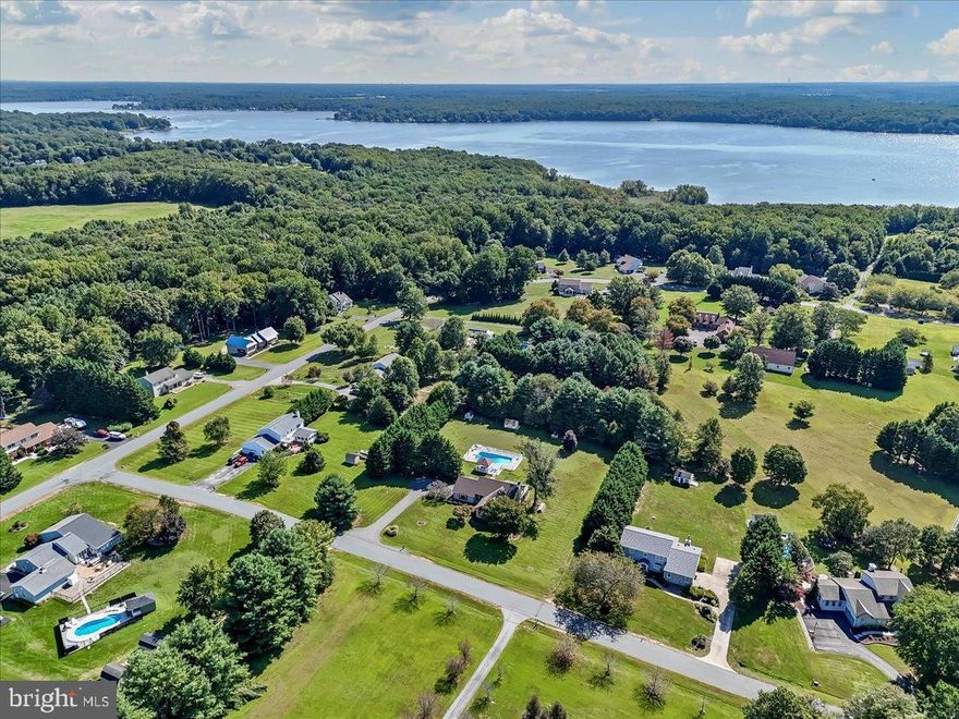 Nestled in the serene community of Pembrey, this exquisite ranch-style residence offers a luxurious lifestyle defined by its stunning water features and unparalleled access to the Elk River. Spanning over 1.55 acres, this property is a true sanctuary. As you approach the home, the charming brick and vinyl siding exterior invites you in, while the meticulously landscaped grounds set the stage for a tranquil retreat. Step inside to discover a thoughtfully designed layout that maximizes space and natural light. With 2,476 square feet of finished living area, this home boasts three spacious bedrooms and two full bathrooms, providing ample room for relaxation and entertainment. The heart of this residence is undoubtedly the outdoor oasis. A personal in-ground pool offers a perfect spot for summer gatherings or quiet afternoons soaking up the sun. Imagine hosting friends for a poolside barbecue or enjoying a refreshing dip after a day on the water. Complimenting the outdoor living space you are greeted by a large Trex Deck some of which is partially covered from the roof making a great space for relaxing after a long day.The property's private access to the Elk River enhances the experience, allowing for effortless boating, fishing, and kayaking from right inside the community. Whether you're an avid water sports enthusiast or simply enjoy the peaceful sounds of nature, this home caters to your every desire. Inside, the cozy ambiance is complemented by a charming fireplace and vaulted ceilings, perfect for those cooler evenings spent indoors. The partially finished basement with a side entrance provides additional space for hobbies or storage, while the attached garage and ample driveway parking ensure convenience for you and your guests. This property is not just a home; it's a lifestyle. The surrounding natural beauty and the gentle flow of the river create a serene backdrop that enhances your everyday living experience. Experience the perfect blend of comfort, elegance, and adventure, all within the confines of your own private retreat! New Roof in 2024, New Septic 2017, with many other upgrades, this property has it all!