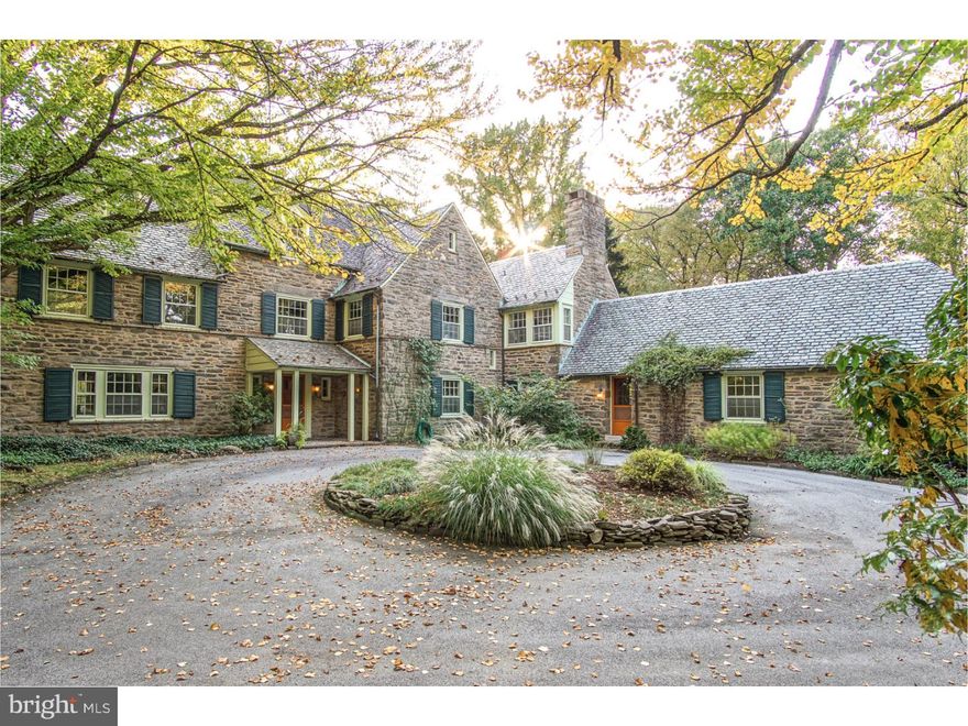 An amazingly beautiful home. Designed by Robert Rodes McGoodwin for the Woodward Corporation and built in 1928, 7312 Emlen Street encompasses 1.42 acres of private land surrounded on 3 sides by Fairmount Park.  Its exquisite natural surroundings are exceeded only by the grace and sophistication of the home itself, a 2 1/2 story stone structure styled as a country estate in the city.  It is in superb condition. Inside are broad sunlit spaces. 1st floor: 30' long center hall entry, 18'x25' living room with fireplace, 14'x30' heated sunroom/family room, 19'x19' formal dining room--all of which look out onto patio, lawns and parkland beyond. Also on first floor: a 31'x14' eat-in family kitchen totally redesigned and installed in 2003 with dual fuel cooking, center island, enormous storage and counter capacity, granite counters, sustainable recycled glass backsplash, with sitting area at one end; utterly charming 17'x12' butler pantry with original and still operating zinc double sink and Victorian dresser; 11'x14' slate-floored breezeway offers exit to driveway, 4-car garage and grounds as well as easy access to a first floor 2-room guest suite with full bath renovated just 6 years ago. 2nd floor: Master bedroom (18'x22')with walk-in closet/dressing room, 2 spacious master baths with extraordinary hand-wrought tile work; 2 more southwest-facing large bedrooms with great closets on either side of a full bath with both tub and stall shower with new lead pan; 12'x9' sitting room/study. 3rd floor: 3 good-sized rooms, plentiful closets, full bath, large attic room for storage.  Full basement with space for utilities, work, play, storage, and laundry with door directly into magnificent Lord & Burnham greenhouse. This greenhouse, approx 24'x42', has been carefully maintained and sports new Spanish cedar upper sashes, circulating pond(not currently used), delightful bas reliefs and whimsical decorative touches. It is complimented by a large potting shed with below-ground utility room.  Both greenhouse and potting shed will be conveyed "as-is", as will a separate cabin at the far end of the grounds overlooking the original pool, now a recirculating pond with fountain. This is a one-of-a-kind property in a location not to be missed: perfectly sited between the popular Chestnut Hill and West Mt. Airy communities, walking distance to commuter trains, shops, restaurants.