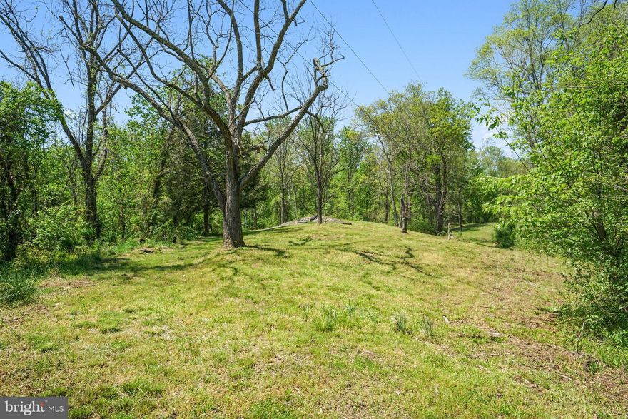 Situated atop a ridge alongside Beaverdam Creek, this secluded seven-acre plot has remained in the possession of a local family for generations. Surrounded by expansive farms and nestled within foxhunting territory, this property boasts an authentic charm. An antique log cabin dating back to 1885 adds to its allure, though it is advised not to enter due to safety concerns. With mature trees and water on two sides, the potential for a striking building site is undeniable.