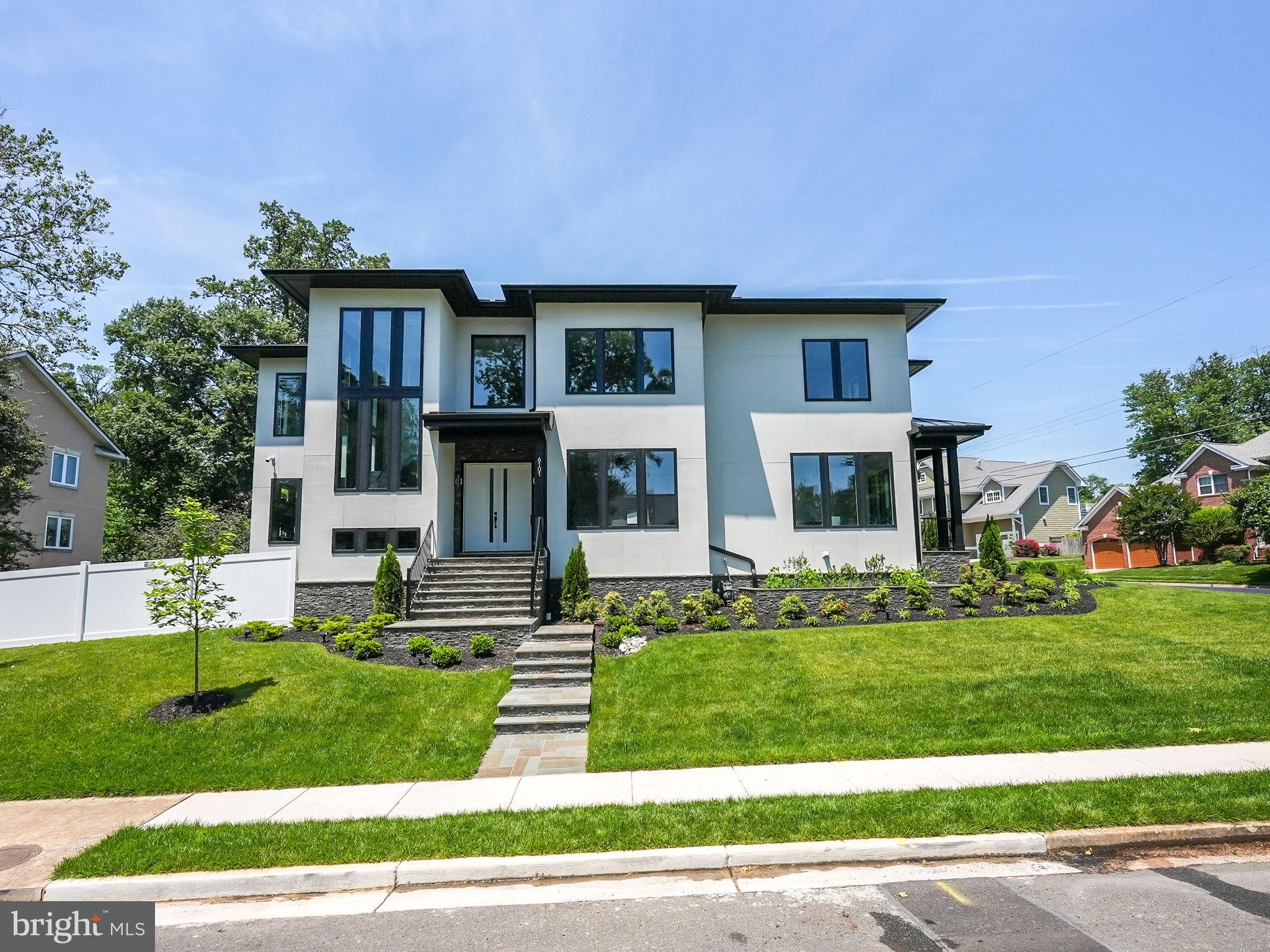 FANTASTIC VALUE WITH A 3 -CAR GARAGE AND ELEVATOR
Indulge in unparalleled luxury in Arlington, VA with this extraordinary modern smart home
boasting an ELEVATOR and a 3-car garage and spanning approximately 6730 sq. ft. Meticulously
crafted and nestled in the sought-after area of North Arlington, this residence
exemplifies exceptional craftsmanship and meticulous attention to detail. Step into the expansive
open floor plan with 10’ ceilings on the main and upper levels and suspended ceilings, a chef’s
kitchen awaits with a sizable Quartz countertop island adorned with stunning pendant lighting
and premium Thermador appliances. The main level features a versatile office space and a 2nd
office or guest room that connects to a full bath. The luxurious primary suite is a sanctuary of its
own, offering a spacious bedroom with a built-in headboard featuring scone lighting, dual
custom closets with quartz/glass countertop organizers, and a spectacular primary bath with
marble heated flooring and two separate quartz floating countertop vanities complemented by
decorative sconce lighting and light-up mirrors. Pamper yourself in the oversized glass-enclosed
shower equipped with four body jets, a rain shower, and a regular and handheld shower head.
Enjoy privacy in the toilet closet and unwind in the separate soaking tub. Discover three
additional en-suite bedrooms, each boasting floating vanities with quartz countertops and light -
up mirrors, along with a large laundry room. The walk-out lower level is a sun-filled entertainer's
dream, featuring a sleek Quartz bar with waterfall quartz countertops and glass shelving, a
spacious rec room, a media room, a 6th en-suite bedroom, and a gym. Four-inch natural
hardwood flooring graces the main and upper floors, while tiled flooring adorns the lower-
level rec room. The outdoor space is adorned with a stone patio, professionally fenced-in
landscaped yard, and a permeable paver driveway leading to a 3-car garage. This home
epitomizes luxury living with its thoughtful design, exquisite finishes, and unparalleled
amenities, making it the ultimate retreat for those seeking an elevated home in Arlington. Please note: Home has security cameras on exterior of home.