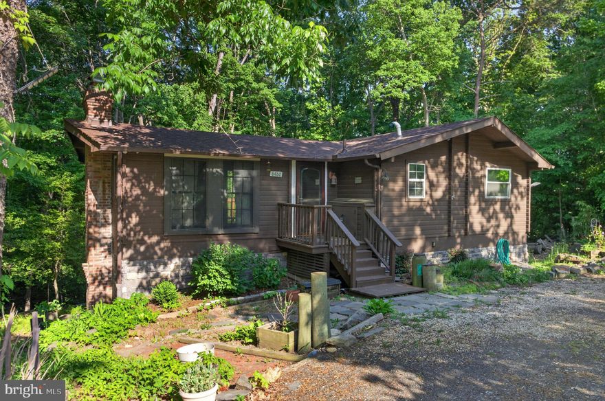 Log cabin 1332 sq. ft home. 2 levels, on 1.16 wooded lot.  Recently completed, this move-in-ready home has undergone a full top -to-bottom renovation with high-quality upgrades throughout. The interior has been thoughtfully upgraded, featuring a brand -new kitchen with modern cabinetry, updated countertops, and new appliances, along with newly installed hardwood flooring  that adds warmth. A new roof has been installed, and  a brand-new two -tier deck has been constructed, offering outdoor living and entertaining space. 
The fully finished basement has also been upgraded and includes a second kitchen, a bar area for entertaining, and a completely renovated bathroom with modern fixtures. The lower level can also serve as a private home office, providing flexible space to fit your lifestyle needs.
Built with cedar logs, this charming cabin style residence provides a peaceful retreat in the heart of the city.