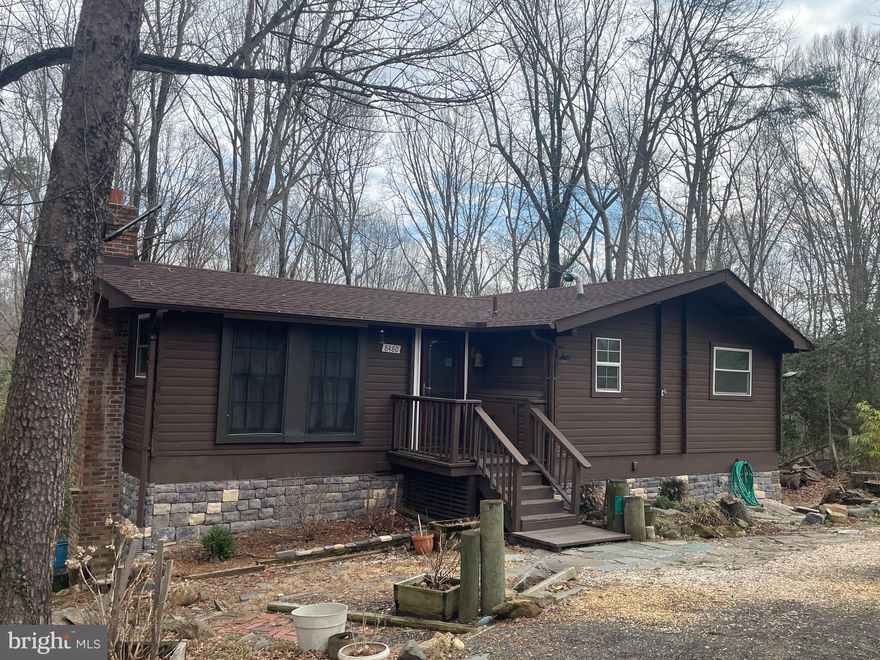 Log cabin 1332 sq. ft home. 2 levels, on 1.16 wooded lot.  Recently completed, this move-in-ready home has undergone a full top -to-bottom renovation with high-quality upgrades throughout. The interior has been thoughtfully upgraded, featuring a brand -new kitchen with modern cabinetry, updated countertops, and new appliances, along with newly installed hardwood flooring  that adds warmth. A new roof has been installed, and  a brand-new two -tier deck has been constructed, offering outdoor living and entertaining space. 
The fully finished basement has also been upgraded and includes a second kitchen, a bar area for entertaining, and a completely renovated bathroom with modern fixtures. The lower level can also serve as a private home office, providing flexible space to fit your lifestyle needs.
Built with cedar logs, this charming cabin style residence provides a peaceful retreat in the heart of the city.