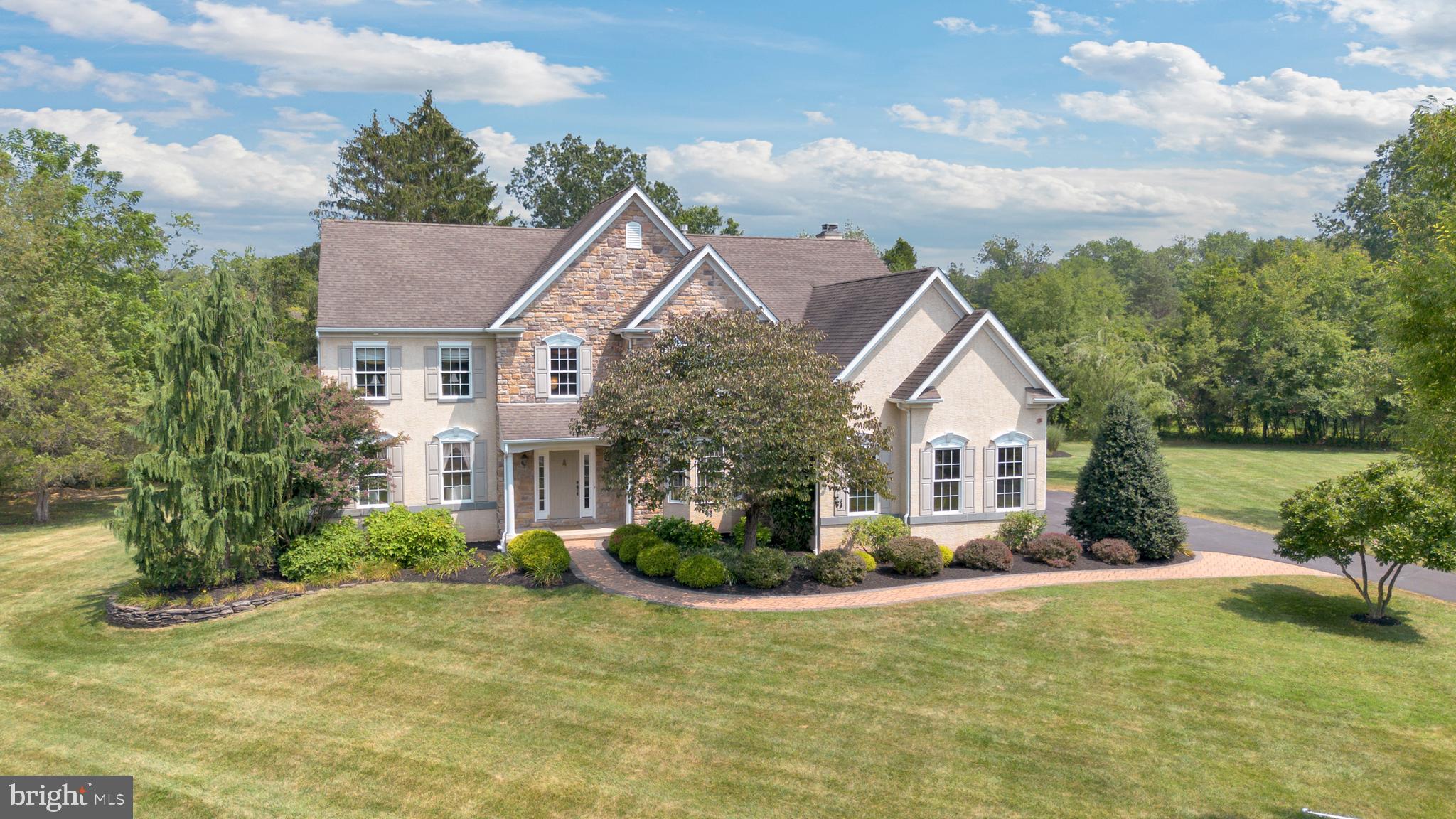 OPEN HOUSE SUNDAY, 8/10/2025, 1-3PM
Welcome to your dream home in Harleysville, nestled on a serene and level 1.5-acre lot in the highly sought-after North Penn School District! This exquisite 4-bedroom, 3.5-bath Colonial offers a rare combination of luxury, comfort, and tranquility— a little piece of paradise in Montgomery County. Step through the charming covered entry into a grand two-story Foyer with a curved staircase, flanked by a private Home Office featuring handsome built-ins, bay window, and French doors. Entertain in style in the elegant Formal Living and Dining rooms, adorned with chair rail and crown molding. The heart of the home is the expansive, custom eat-in Kitchen boasting rich cabinetry, granite countertops, a large center island, and a cozy breakfast/lounging area with access to the spacious back deck, paver patio, and beautifully-manicured backyard with shed, designated garden area and perennial flower beds. Back inside, don’t miss the walk-in custom Pantry with granite counters and wood shelving, or the stylish powder room and laundry room—complete with granite folding space and built-ins—leading to the oversized 3-car Garage. Soaring ceilings and a wall of windows invite you into the impressive two-story Family Room featuring a built-in, fan-forced, wood burning stove (fireplace), hand-scraped hardwood floors, and a convenient back staircase. On the Upper Level, find a generous landing and a luxurious Primary Suite with dedicated Bedroom space adjoined by sitting area, large walk-in closet, and ensuite Bath. The secondary Bed/Bath combo (aka the Princess Suite) includes its own private Bath, while two additional Bedrooms share a recently renovated Jack & Jill Bathroom with Hall access. The finished Lower Level is an entertainer’s dream with a wet bar, tray ceilings, built-ins, and custom details throughout. There is also ample dry storage and a full workshop with built-in cabinetry ready for you to start your next project. With over-the-top upgrades and an idyllic setting just minutes from major commuting routes, shopping & dining in Skippack and surrounding areas, and recreational activities in local parks—this home truly has it all. Showings begin Friday, 8/8/25, with an OPEN HOUSE Sunday, 8/10/25, 1-3pm. Don't miss your chance to call this stunning property home!