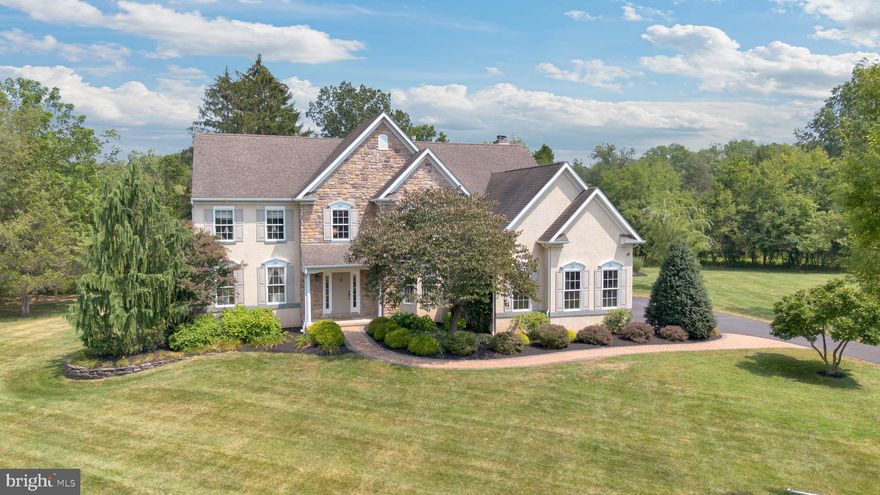 Welcome to your dream home in Harleysville, nestled on a serene and level 1.5-acre lot in the highly sought-after North Penn School District! This exquisite 4-bedroom, 3.5-bath Colonial offers a rare combination of luxury, comfort, and tranquility— a little piece of paradise in Montgomery County. Step through the charming covered entry into a grand two-story Foyer with a curved staircase, flanked by a private Home Office featuring handsome built-ins, bay window, and French doors. Entertain in style in the elegant Formal Living and Dining rooms, adorned with chair rail and crown molding. The heart of the home is the expansive, custom eat-in Kitchen boasting rich cabinetry, granite countertops, a large center island, and a cozy breakfast/lounging area with access to the spacious back deck, paver patio, and beautifully-manicured backyard with shed, designated garden area and perennial flower beds. Back inside, don’t miss the walk-in custom Pantry with granite counters and wood shelving, or the stylish powder room and laundry room—complete with granite folding space and built-ins—leading to the oversized 3-car Garage. Soaring ceilings and a wall of windows invite you into the impressive two-story Family Room featuring a built-in, fan-forced, wood burning stove (fireplace), hand-scraped hardwood floors, and a convenient back staircase. On the Upper Level, find a generous landing and a luxurious Primary Suite with dedicated Bedroom space adjoined by  sitting area, large walk-in closet, and ensuite Bath. The secondary Bed/Bath combo (aka the Princess Suite) includes its own private Bath, while two additional Bedrooms share a recently renovated Jack & Jill Bathroom with Hall access. The finished Lower Level is an entertainer’s dream with a wet bar, tray ceilings, built-ins, and custom details throughout. There is also ample dry storage and a full workshop with built-in cabinetry ready for you to start your next project. With over-the-top upgrades and an idyllic setting just minutes from major commuting routes, shopping & dining in Skippack and surrounding areas, and recreational activities in local parks—this home truly has it all.
Don't miss your chance to call this stunning property home!