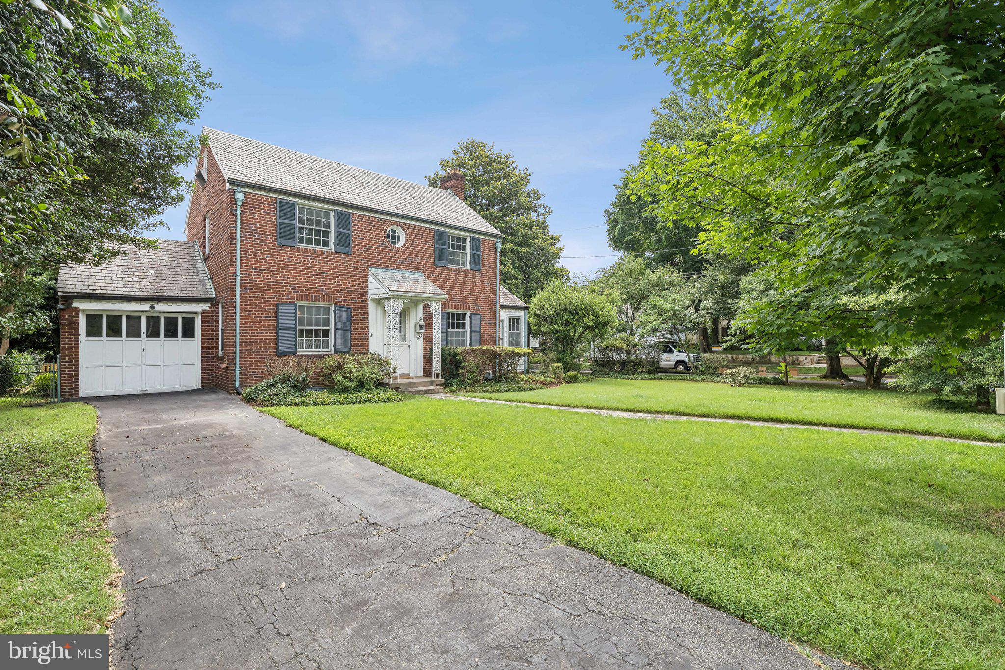 Set on a corner lot in the coveted Village of Martin’s Additions, this 3 bedroom, 1.75 bath brick colonial offers timeless character and exciting potential. Built in 1939 and lovingly maintained by one family for generations, it features an original slate roof, hardwood floors, and bold vintage wallpaper that proves good trends always come back in style.
Inside, you'll find a cozy wood-burning fireplace, formal dining room, enclosed side porch, and a traditional layout ready for your vision. The upper level includes a full bath, with a half bath on the main floor and a quarter bath in the walkout basement. Additional highlights include an attached 1-car garage, a fenced yard, and rare off-street parking- a highly coveted feature in this area where street parking can be limited on narrow streets. Major system updates include a 2024 hot water heater and 2017 gas furnace.
The community is known for its neighborly spirit, active listserv, seasonal events, and local perks. Just one block away, enjoy beloved local favorites including La Ferme, Olympia Cafe, Brookville Market, Brookville Pharmacy, a barber shop, and more. With the DC line less than a mile away and easy access to bus routes and commuter corridors, it’s a dream location for getting around town. Outdoor lovers will appreciate nearby Chevy Chase Local Park with its baseball field, tennis court, playground, and open space for all ages.
Sold strictly as-is, this home is a rare opportunity to restore, reimagine, or renovate in one of Chevy Chase’s most cherished neighborhoods. Whether you're an investor, renovator, or a buyer with a vision, this is your chance to bring new life to a classic.