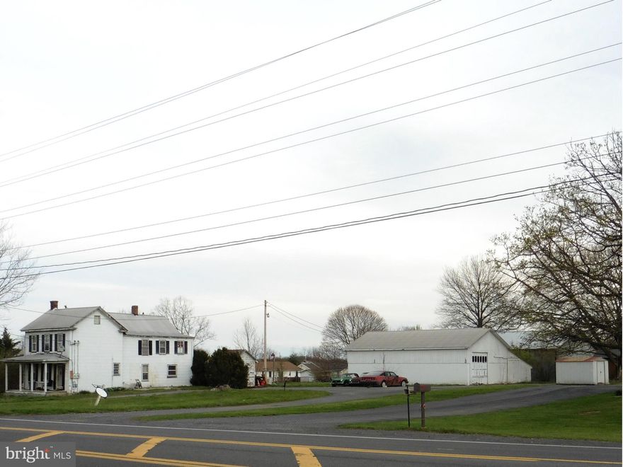 1.28 Level acres with 221' frontage on Winchester Ave (U.S.Rt.11).  Excellent location and no deed restrictions. Close to VA line and site of new Amazon building. Two large garages with concrete floors, hoists, metal roof and free span construction. Larger one has two overhead doors.  House is divided into apts. A desirable location for any type business, auto mechanic, retail, etc..