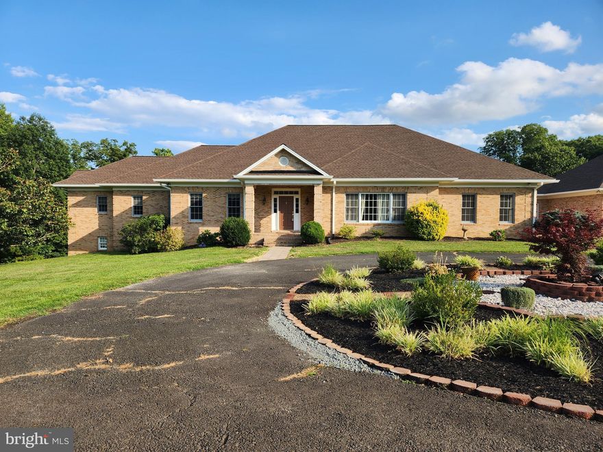 Reduced rent on this exclusive custom build home nestled in privacy yet conveniently located near shopping. This brick & stone raised ranch was built with fine craftsmanship, featuring hardwood flooring throughout the main level and custom cabinetry in the kitchen.  On the main floor there are 2 wings with living quarters comprised of 2 bedrooms on each side. There is also a formal living room which may be used for a study/office with plenty of natural light. If you like to entertain this home has it all, from a formal dining room and gourmet kitchen, to a spacious downstairs with plenty of space to set up a game room and entertainment center. If you have an artist in the family, there is an additional room downstairs that has been outfitted with great lighting for an art studio.  Want to protect your vehicles from the elements? This home has a 3  full size vehicle garage that is  connected to the house.   For added peace of mind there is a whole house backup generator. Verizon Internet is available.