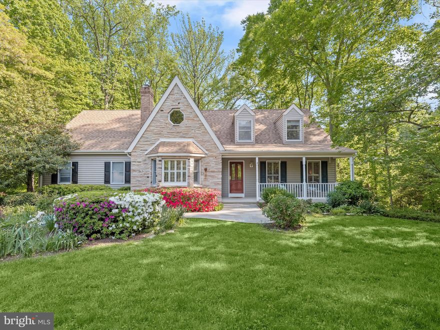 Welcome to the desirable Annapolis community of Carriage Hills where this well-maintained home, cherished by its original owner, awaits. With charming architectural details reminiscent of a cottage, including stone accents and a covered front porch, this residence exudes warmth and character. Situated on nearly an acre of land that extends into serene wooded surroundings, enjoy the tranquility of nature right in your backyard. Inside, the home boasts many wonderful features including main level living with a primary bedroom, a cozy fireplace, an expansive composite deck, and light-filled interiors adorned with crown molding and custom window treatments that create an inviting atmosphere. The living room impresses with a cathedral ceiling, 2-story stone fireplace, French doors, and hardwood floors that flow through much of the main level. The kitchen offers sleek GE appliances, ample cabinetry with roll-out shelves, and a breakfast table space with deck access. A formal dining room, featuring a triple pane sliding glass door like the breakfast room, provides an ideal setting for gatherings. The primary bedroom offers a serene retreat with its spacious layout, walk-in closet, and en-suite bath featuring a double sink vanity, spa-like soaking tub, and shower with a frameless glass door. The laundry room, equipped with ample cabinetry, ensures convenience, while the adjacent powder room adds practicality to daily living on the main level. Upstairs, discover three additional bedrooms, a loft family room with a wet bar, and a double sink vanity full bath with split layout designed for simultaneous use.  The unfinished walkout lower level provides storage space and potential for customization with a rough-in for a full bath. Residents can enjoy community amenities including a playground, tennis, pickleball, and basketball courts. Conveniently located near downtown Annapolis, boutique shops, restaurants, and the Naval Academy, this home also offers easy access to Metro and DC for commuting. Don't miss the opportunity to experience the quintessential Annapolis lifestyle in this captivating residence. Property Updates: heat pump, water tank, dishwasher, kitchen and dining room refinished hardwood flooring, kitchen, laundry and powder room paint, and more.