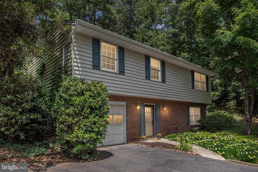 Fantastic price for a single family home located in the City. Great layout with ample living space. Nestled in the woods, this home provides privacy, peace and tranquility. Amazing park-like yard with large rear deck. Three nice-sized bedrooms and two full baths are featured on the upper level. Master bedroom offers private full bath and walk-in closet with views overlooking the wooded rear yard. Kitchen with updated SS appliances, French door refrigerator and wood floors. Great family room on lower level with wood burning brick fireplace. Many recent improvements to include HVAC and hot water heater. This home is a charmer. Enjoy the convenience of city living and this home's private setting!