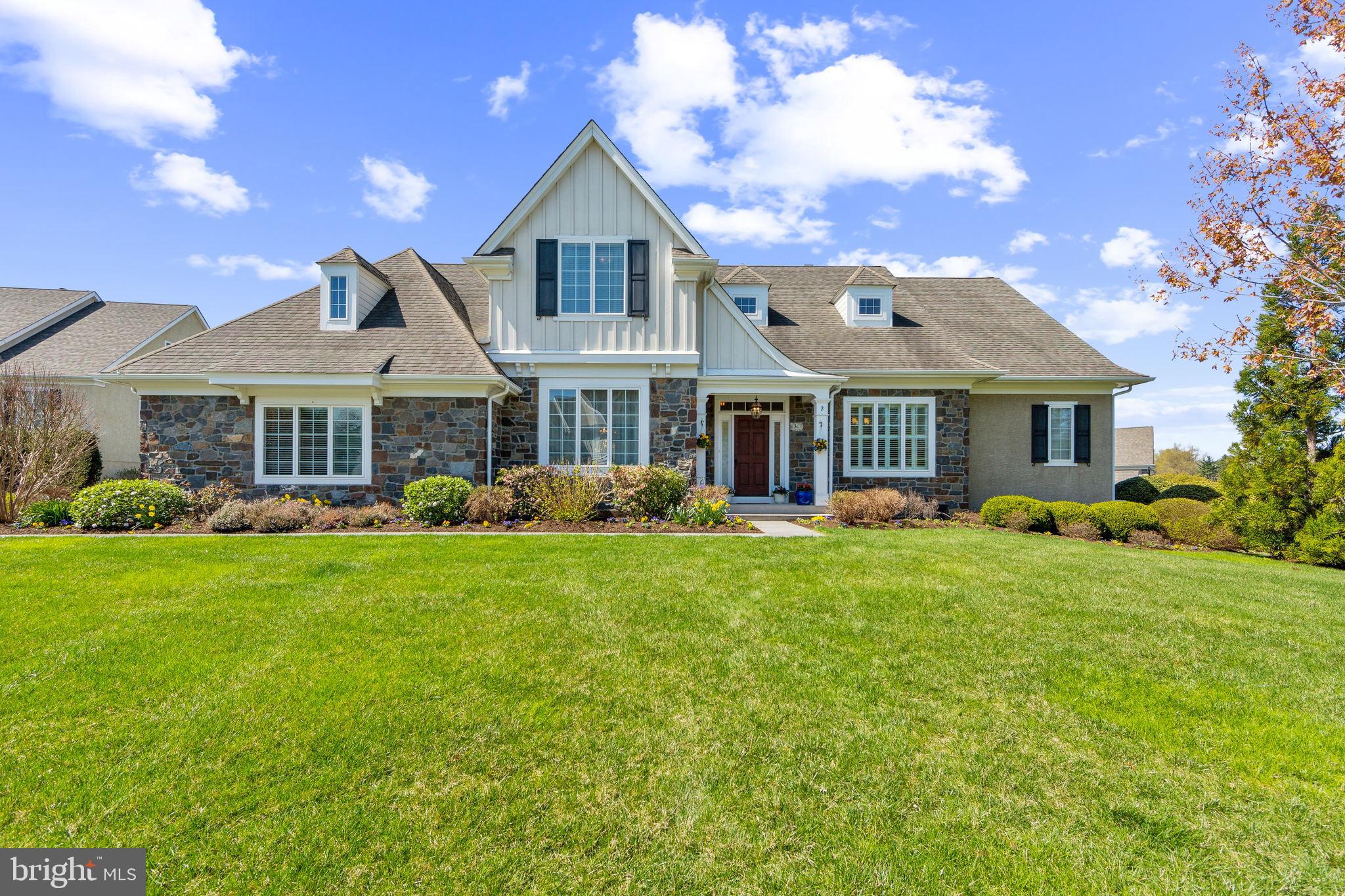 Welcome to 2 Wellfleet Lane—an impeccably maintained residence tucked away on a premier cul-de-sac homesite in the prestigious Andover community. Built by award-winning Vaughan & Sautter Builders, this exquisite home backs to open space and scenic walking trails, offering tranquil views, understated elegance, and refined living in the heart of Thornbury Township. From the moment you step inside, natural sunlight pours through oversized windows, highlighting soaring cathedral ceilings in the foyer and family room, along with site-finished hardwood floors throughout the main level. Architectural details abound—including custom millwork such as tray ceilings, two-piece crown moldings, raised panel wainscoting, and a paneled gas fireplace flanked by built-in bookcases. The gourmet kitchen is a chef’s dream featuring a granite island with furniture leg detail, staggered-height cabinetry, upgraded backsplash, and high-end appliances including a Viking 6-burner gas range, convection oven, and a built-in custom hutch. The sunny breakfast nook overlooks the expansive, maintenance-free composite deck with retractable awning, ideal for al fresco dining or entertaining. The luxurious first-floor primary suite offers dual vanities, a built-in soaking tub with ceramic surround, and an oversized frameless glass shower. The butler’s pantry and spacious mudroom adjacent to the laundry room combine convenience with functionality. Upstairs, a hardwood-floored loft overlooks the great room below and leads to three spacious bedrooms, including an expanded bedroom with a spacious closet with custom closet system including closet depth shelves, plus two additional full baths. But wait, there's more! The finished lower level features cork flooring and offers a fifth bedroom with full bath, outside entrance with patio, a sound proof media room with wet bar and mini kitchenette, and a home gym, plus flex space with ample storage in the unfinished area. Additional highlights include surround sound, a home security system, state-of-the-art water manifold system, whole house generator, commercial grade appliances. lawn irrigation system and more. Located within the award-winning West Chester Area School District, this home offers exceptional access to major routes, shopping, dining, and area recreation.