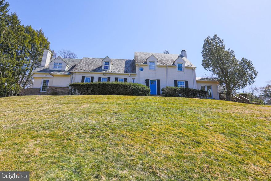 Extraordinary four bedroom, six-and-a-half-bathroom 6,000 square foot residence on 1.42 acres in the highly sought-after enclave of historic Burnt Mills Hills. Circa 1936, designed by acclaimed architect John Nutte, this remarkable timeless stone, brick, and slate-roof manor home has been extensively renovated over the years. This property artfully combines old world charm with luxury modern features – there are stunning architectural details and elegant appointments including expansive rooms flooded with light, four fireplaces, detailed molding, modern lighting, French doors, exposed brick walls, beamed and coffered ceilings, and stone wall accents. Entertain and live-in style while enjoying the great flow of the welcoming foyer entry, inviting parlor / sitting room, sun-filled living room with a fireplace, and a banquet sized dining room with a separate fireplace.  The remodeled, gourmet kitchen features granite counters, ample prep space, voluminous Maple cabinetry, stainless steel appliances including a six-burner Viking stove, exposed brick walls, coffered ceiling and adjoining breakfast room with built-in bench seating and picturesque backyard views.  The main level is complete with an enchanting stone-walled, beamed ceiling family room with fireplace, a glorious three-sided sunroom that opens to the deck, and a full bathroom plus a powder room. The incomparable upper-level layout boasts four bedrooms and four full bathrooms, including the exquisite primary bedroom suite featuring a walk-in closet and private renovated bathroom with a double vanity with vessel sinks, and an oversized walk-in shower with dual shower heads. The lower level offers even more space with a recreation room with recessed lighting and a fireplace, which could be used as a bedroom along with  a full bathroom, and a workshop area. This property is superbly located near the wonderful dining, shopping, and entertainment of downtown Silver Spring. Located near the FDA as well as many neighborhood parks including Pinecrest Park, North Four Corners Local Park and Northwest Branch Park. Easy access to I-495, New Hampshire Ave, and Columbia Pike.  The incomparable upper-level layout boasts four bedrooms and four full bathrooms, including the exquisite primary bedroom suite featuring a walk-in closet and private renovated bathroom with a double vanity with vessel sinks, and an oversized walk-in shower with dual shower heads. The lower level offers even more space with a recreation room with recessed lighting and a fireplace, a full bathroom, and a workshop area. This property is superbly located near the wonderful dining, shopping, and entertainment of downtown Silver Spring. Located near the FDA as well as many neighborhood parks including Pinecrest Park, North Four Corners Local Park and Northwest Branch Park. Easy access to I-495, New Hampshire Ave, and Columbia Pike.