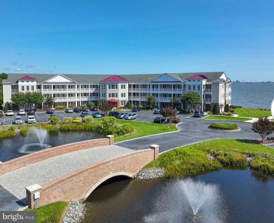 Gorgeous, completely remodeled and fully furnished three-bedroom, two-bath top-floor unit is now available in the desirable Points Reach Building 2! You will enjoy panoramic water views of the Ocean City skyline, the Assawoman Bay, and Manklin Creek.  The entry to the lobby of the building includes tile walkways and grand curved staircases that frame the elevator to your door. Step inside to discover an open-concept floor plan with soaring 10-foot ceilings, brand new flooring, elegant wainscoting, and refined crown and base moldings throughout. The freshly painted interiors feature serene coastal hues. The spacious gourmet kitchen impresses with granite countertops, upscale cabinetry, a breakfast bar, and a butler’s pantry—all seamlessly connected to the dining and living areas with a cozy gas fireplace. The sliding glass doors in the living room open to a deck with exceptional water views. The private, spacious deck features a built-in outdoor gas grill, perfect for year-round outdoor entertainment.   The bay-front primary suite offers exceptional views and opens to your private balcony, two walk-in closets, a bath with a jetted tub & shower, and double sinks.  The unit features an Efficient Geothermal Heat Pump.  Points Reach’s “Bike Barn” offers a locked storage unit (#14 on the second floor) for storing your bikes, beach toys, and seasonal decor. The condo fees include flood hazard insurance, bi-annual check of the geothermal system, annual check of the gas grill, water, trash, and landscaping, bike barn, and parking lot. All this and all that amenity-filled Ocean Pines has to offer, including indoor and outdoor pools, an oceanfront beach club in Ocean City, marinas to keep your boat, Robert Trent Jones golf course, a new Clubhouse at the Yacht Club, tennis & pickle ball courts, playgrounds, and more! If you are looking for the ultimate carefree waterfront lifestyle beyond the beach with no maintenance, this is it!