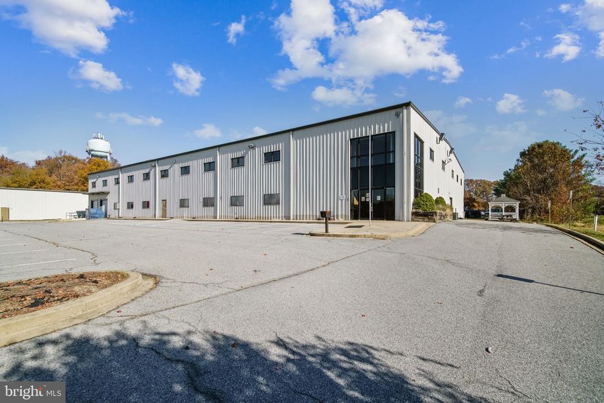 Warehouse building with improved office space for sale in Prince Frederick, Maryland. This building has  approximately 20,000 SF of well-built out office space with large offices, managerial suites,  conference rooms, cubicle space, a designated lunch area, kitchenettes, an elevator and more.  There is  approximately  40,000 SF of warehouse space that also has metal constructed mezzanine space that will convey with the sale. There are numerous loading docks and drive in doors. The entire building is sprinklered, connected to natural gas and has a high electrical output. The property is situated on a private piece of land with a great paved and marked parking lot.