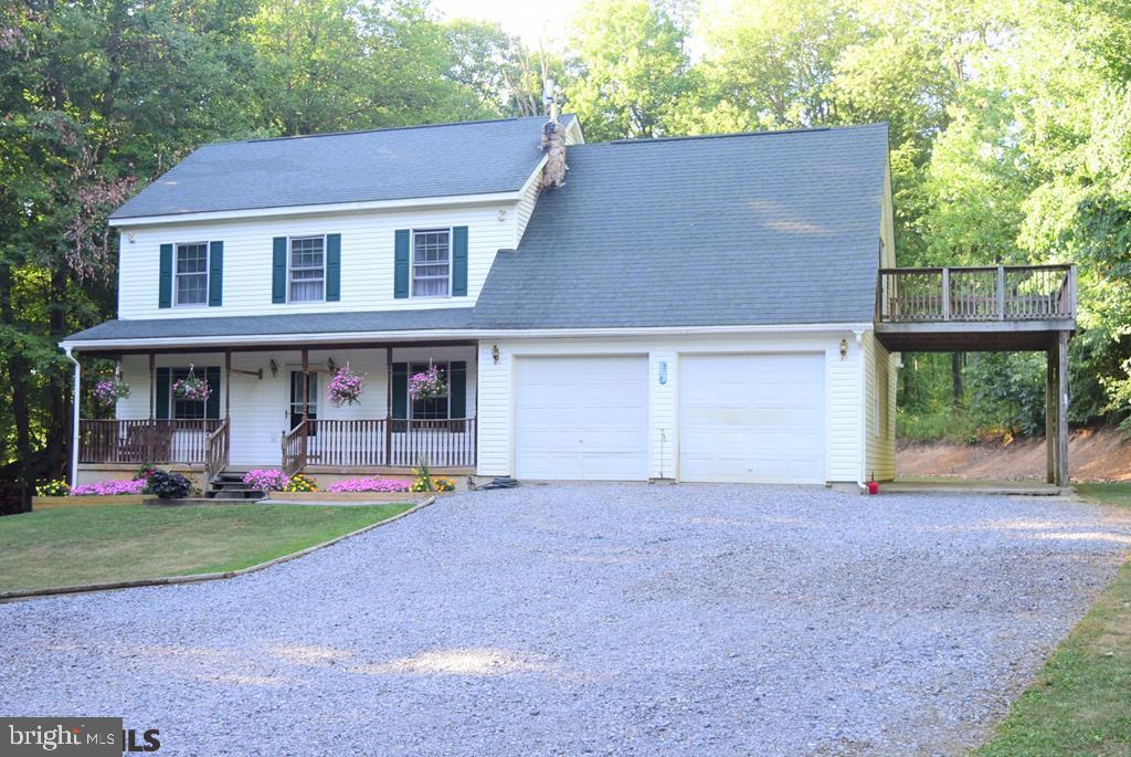 Private 5.18 acre wooded lot with a 2003 two-story home. Home has 2462 finished sq ft with 4 bedrooms and 2 full baths on a full unfinished basement. There is a deck off of the 4th bedroom which forms a 3rd stall carport. Large shed presently set up as horse stall/barn. Price reflects AS-IS condition.