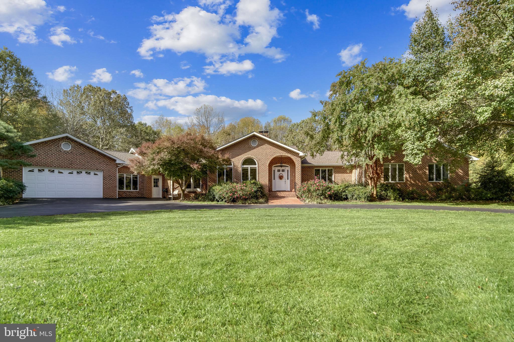 Stunning and expansive 4700+sqft brick rambler on 2 acres in highly desirable Locust Grove Estates! This sprawling 4 bedroom, 4 bathroom immaculate home captivates at every turn from the updated gourmet kitchen, updated baths, 10ft ceilings, gleaming hardwoods, neutral paint, picture windows, recessed lighting, french doors, and expansive room sizes. You will be pleased! The gourmet kitchen delights with granite countertops, tile backsplash, stainless steel appliances, recessed lighting, a large pantry, island and breakfast area. Sophistication awaits in the spacious dining room, perfect for a large dining table to fit plenty of family and friends. The spacious family room features a brick fireplace with gas insert and a wall of picture windows overlooking the beautifully landscaped yard. Adjacent is an office with vaulted ceiling, custom built bookshelves and desk. The bedroom wing awaits down the hall featuring a primary bedroom with a vaulted ceiling, two closets, an updated ensuite bath with double vanity with granite countertops and a large tiled shower with glass door. Two additional bedrooms and a full bath complete the bedroom wing. The main floor is rounded out by a laundry room off of the kichen, a full bathroom and mudroom that leads to a multipurpose room with 12ft+ceilings currently being used as a fitness and playroom. The mainly above grade, walk-out lower level features a spacious and versatile recreation room with bar, fireplace and doors to the outdoor patio. A guest's retreat (or in-law suite, rental apartment) with separate walk-out entrance offers a newly renovated kitchen with white cabinets, subway tile, new appliances, dining area, family room, and bedroom with a walk-in closet. Appreciate a second laundry room, several multi-purpose finished rooms/areas for hobbies, a workshop or storage. The backyard is a true retreat with lush green grass lined with mature trees, brilliant flowering ornamental bushes, trees and gardens. A patio with pergula is perfect for those al fresco meals or relaxing under the stars. Charming shed with run-in and fence affords space for animals (invisible fence is installed around the property) and additional space for lawn and garden tools/supplies. An attached garage offers plenty of space for 2 cars, storage and workbench. And an adjacent over-sized heated and cooled garage satisfies the boat and/or RV enthusiast! No detail is overlooked in this thoughtfully designed and updated rambler. Newly installed 30year architectural shingled roof with warranty. Newer HVAC systems (dual zone, propane backup). Don't delay, enter the brick apron circular driveway at 7715 Locust Place, stroll up the newly bricked front walk and open the front door to your dream home! Please be sure to check out: https://tour.truplace.com/property/2232/93312/