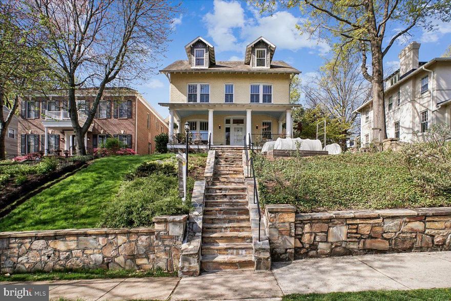 A front porch, a swing, and an immediate sense of arrival. Homes of this caliber are seldom available. This fully reimagined 1918 Rosemont residence honors its architectural heritage while offering a level of detail and atmosphere that is simply hard to replicate. Inside, a light filled foyer and sweeping staircase create a striking first impression, where original stained glass windows catch the morning light and add a layer of character you do not often find. Original 1918 hardwood floors, soaring ceilings, and abundant natural light carry throughout, creating an airy, refined atmosphere from room to room.

The living room offers a warm and inviting space to gather, complete with a charming window seat with built in storage and classic plantation shutters. A pocket door leads to the dining room, where a fireplace anchors the space and adds to the home’s timeless appeal.

Designed for both elegant entertaining and effortless daily living, the kitchen is both functional and inviting, featuring classic beadboard cabinetry, a large pantry, and a sunlit breakfast nook overlooking the garden, an ideal setting for everyday moments.

Outdoors, the experience continues with a beautifully curated backyard centered around a stone fireplace, offering a warm and inviting space for evenings under the stars or relaxed weekend gatherings.
Upstairs, four well proportioned bedrooms provide flexibility, including a sophisticated primary suite with three closets and an updated bath designed for comfort and retreat. One of the secondary bedrooms features a charming adjoining space, likely once a sleeping porch, offering a unique and versatile extension of the room. 

The uppermost level offers exceptional versatility and privacy, ideal as an additional bedroom suite, home office, or family room. Complete with an en suite bathroom, walk-in closet, and custom built-ins, this space also includes an adjoining sitting room and captures a beautiful view of the top of George Washington Masonic National Memorial, adding a distinctive and memorable backdrop.

A spacious lower level offers exceptional scale with multiple areas for storage, making it easy to keep everything organized and out of sight. From both the first, second and third floors you can enjoy soft morning light and peaceful sunrise views, an understated luxury that defines the home’s ambiance.

This is a home that feels different the moment you walk in, and one that stays with you long after you leave.