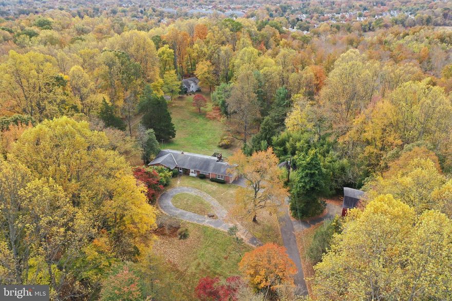 This home has been pre-listing appraised (see documents for copy of appraisal) Discover the rare opportunity to breathe new life into a timeless 1965 brick rambler set on an expansive and picturesque 2.49 acres. This classic home is ready to shine again—offering a rewarding renovation project for those who appreciate character, craftsmanship, and the chance to reimagine a truly special property.
The main level features a generous layout with four bedrooms and two full baths, including a primary suite complete with its own full bath and a walk-in closet fitted with built-ins. A welcoming family room off the kitchen showcases a charming brick fireplace and built-in cabinetry, creating a cozy space to gather. The formal living room, framed by windows that overlook the serene rear yard, offers peaceful views and endless potential for elegant entertaining. The kitchen, equipped with both a breakfast peninsula and table space, is ready for a fresh vision tailored to your style.
The fully finished lower level expands the home’s livable footprint with an additional bedroom, full bath, and an expansive recreation room anchored by a second brick fireplace. A convenient walk-out leads directly to the rear yard, making indoor-outdoor living effortless. This level also includes a large storage/bonus room and a dedicated laundry room, providing excellent flexibility for future customization.
Outdoors, the property offers unique features rarely found in today’s market. The land hosts an all-glass solarium party room, perfect for gatherings or creative restoration. A barn with full concrete flooring and a complete upper-level with swing door adds valuable utility, while a separate concrete-floored storage barn provides even more functional space. A gazebo sits quietly on the grounds, waiting to be revived as a centerpiece for outdoor enjoyment. The rear deck, in need of significant renovation, offers an exciting opportunity to design the ideal outdoor retreat (please use caution if you step onto the deck.)
This is more than a home—it’s a canvas full of potential. Bring your vision, creativity, and passion for restoration to transform this classic rambler into the showpiece it’s ready to become. Offer instructions: ALL OFFERS MUST BE IN A PDF FORMAT AND MAR REALTOR CONTRACT AND ADDENDUMS ARE REQUIRED. NO LETTERS OF INTENT TO PURCHASE WILL BE SUBMITTED TO SELLERS.