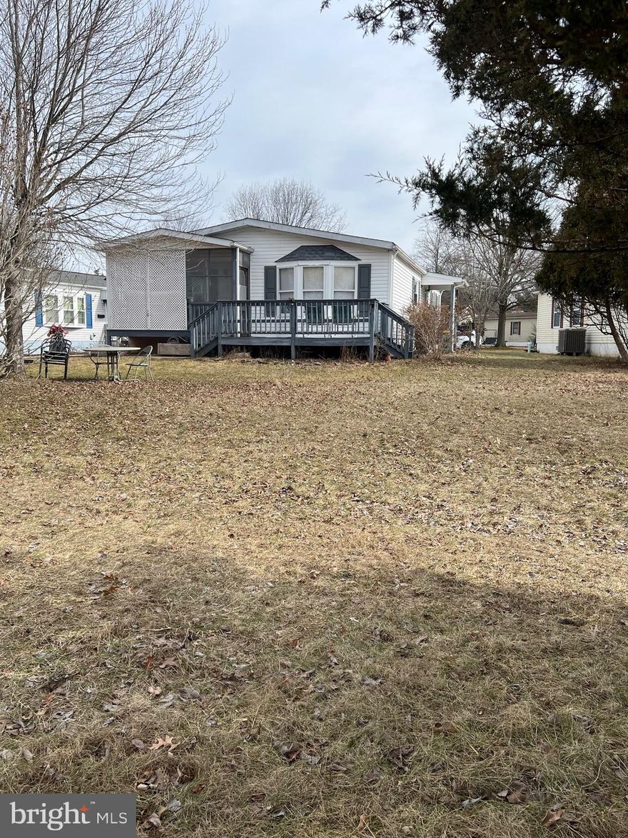 Welcome to this 2 bedroom, 2 bath manufactured home offering peaceful living and wide-open views.  Nestled at the edge of sprawling fields, this property provides a rare sense of privacy and connection to nature - sit back and enjoy your morning coffee while watching deer wander through the field right behind your home.  Inside you'll find a freshly painted space,  open floor plan with a comfortable living area that flows effortlessly into the dining space and kitchen.  Speaking of kitchen, wait until you see the makeover, just so warm and comforting  with a small island for extra counter space.  The two bedrooms,  with new carpet,  are positioned for privacy, each with easy access to a full bath of their own.   Move in ready and full of charm - this is the home where comfort meets natural beauty yet close to town for all your shopping needs.