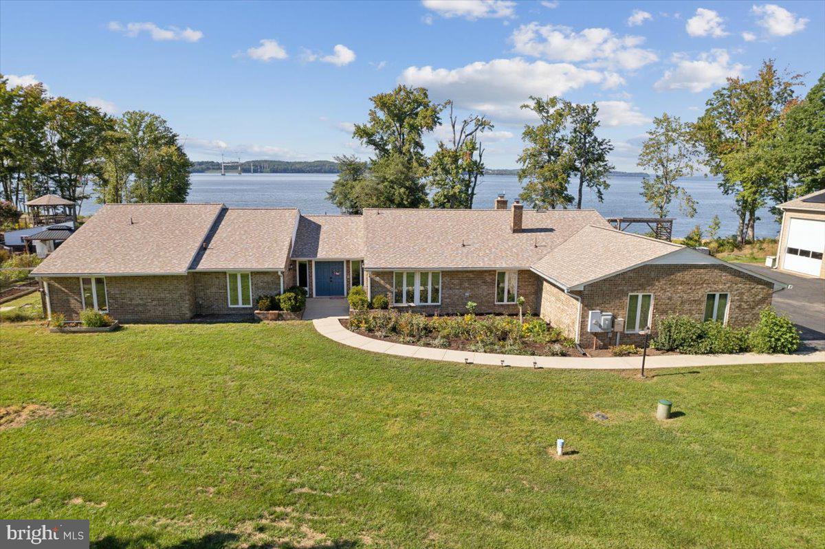 One of a kind waterfront 3,740 square foot all brick rambler located on the Potomac River. This 4 bedroom, 3.5 bath home includes an in-ground pool, 250’ deepwater dock with 2 boat lifts, 2 jets lifts and 300’ of riverfront beach access on 6.58 acres. It has an attached 3-car garage, PLUS a Texas-sized 52' X 62' detached workshop and so much more! The detached all brick workshop has 2 oversized 20' X 14' commercial doors for RVs or boats, plus a side garage bay door with a 10,000 pound car lift. It is also equipped with electric, water, AC and has a full kitchen and bathroom. 



This house not only checks all the boxes, but creates a few must haves that you may have not known you needed. It includes designer wallpaper and paint throughout with new LVP floors, designer light fixtures and spectacular views of the Potomac River from almost every room. The formal foyer includes double doors and custom ceramic tile leading into the expansive sunken family room that boasts plenty of space to relax and entertain family and friends. The large dining room connects to the kitchen with 42' oak cabinets, modern appliances, Corian countertops and breakfast nook area with river views as well. The parlor room is fantastic with custom built-in cabinets and stone fireplace. Just beyond the parlor is the bonus room that can be another sitting room, home office, exercise or 2nd family room. The bedrooms are large and consistent with the rest of the home offering plenty of space and detailed design. Owner's suite looks out on the beautiful view of the river. It is spacious with doors leading outside to the pool. It includes double walk-in closets and a newly remodeled bathroom with soaking tub, ceramic tile, double bowl vanity and custom fixtures.


The outside just does not stop. Grill out on the large concrete patio, which stretches across the entire back of the house for endless views. The 20' x 40' pool is fully equipped with a diving board, double gazebos and pool storage house. The property also has a fenced-in terraced garden perfect for flowers and vegetables. There is a very large chicken coop plus a kids playground. In addition, both home and workshop include a new roof and solar panels. This is a once in a generation chance to own your dream home, please set up a tour as soon as you can.